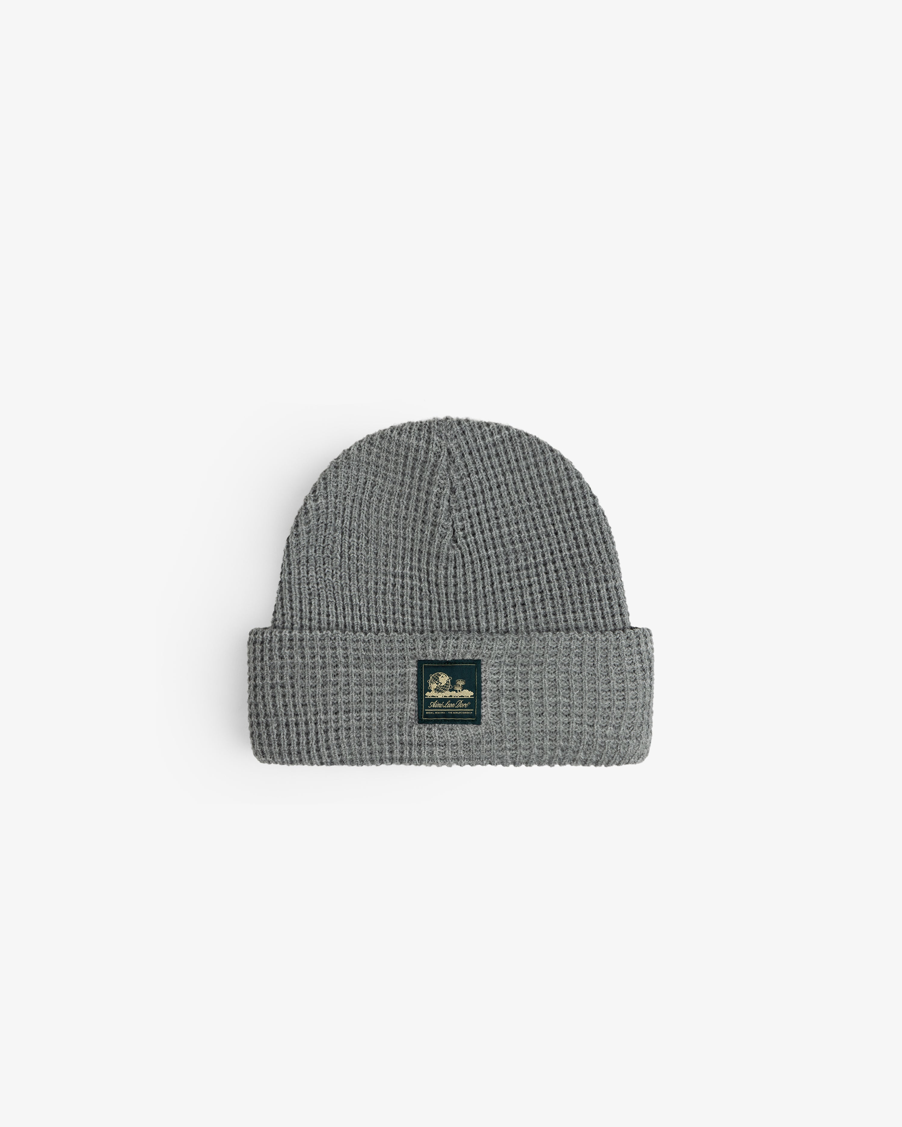 Waffle Knit Beanie in gray with folded brim and black front patch, displayed on a white background.