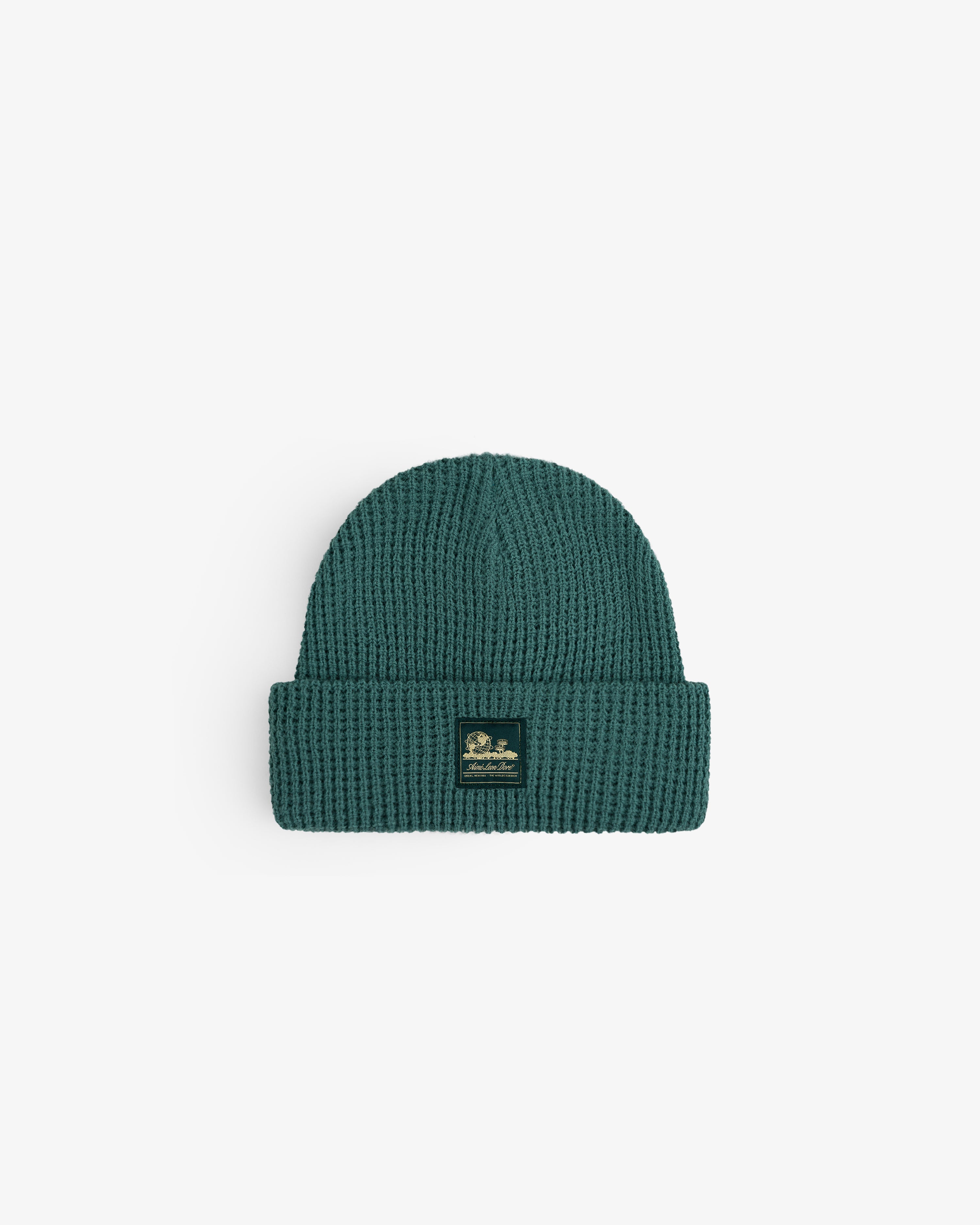Waffle Knit Beanie in teal with folded brim, small front label, shown on a white background.