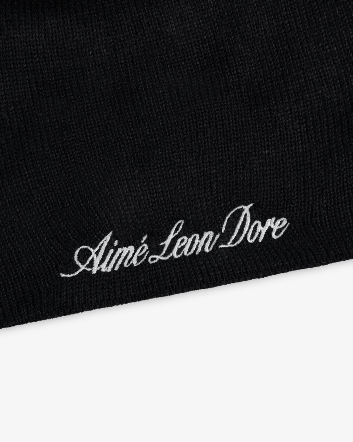 Black ALD / New Era Yankees beanie with white embroidered text.