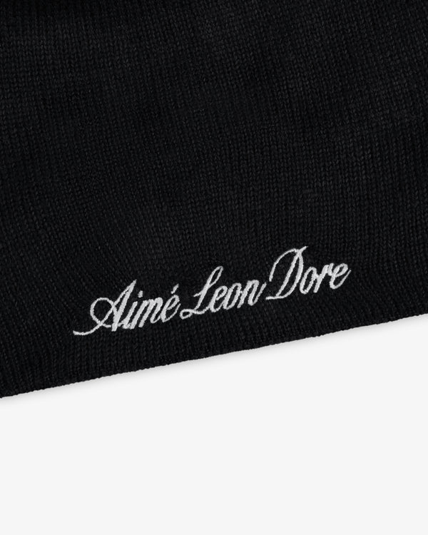 Black ALD / New Era Yankees beanie with white embroidered text.