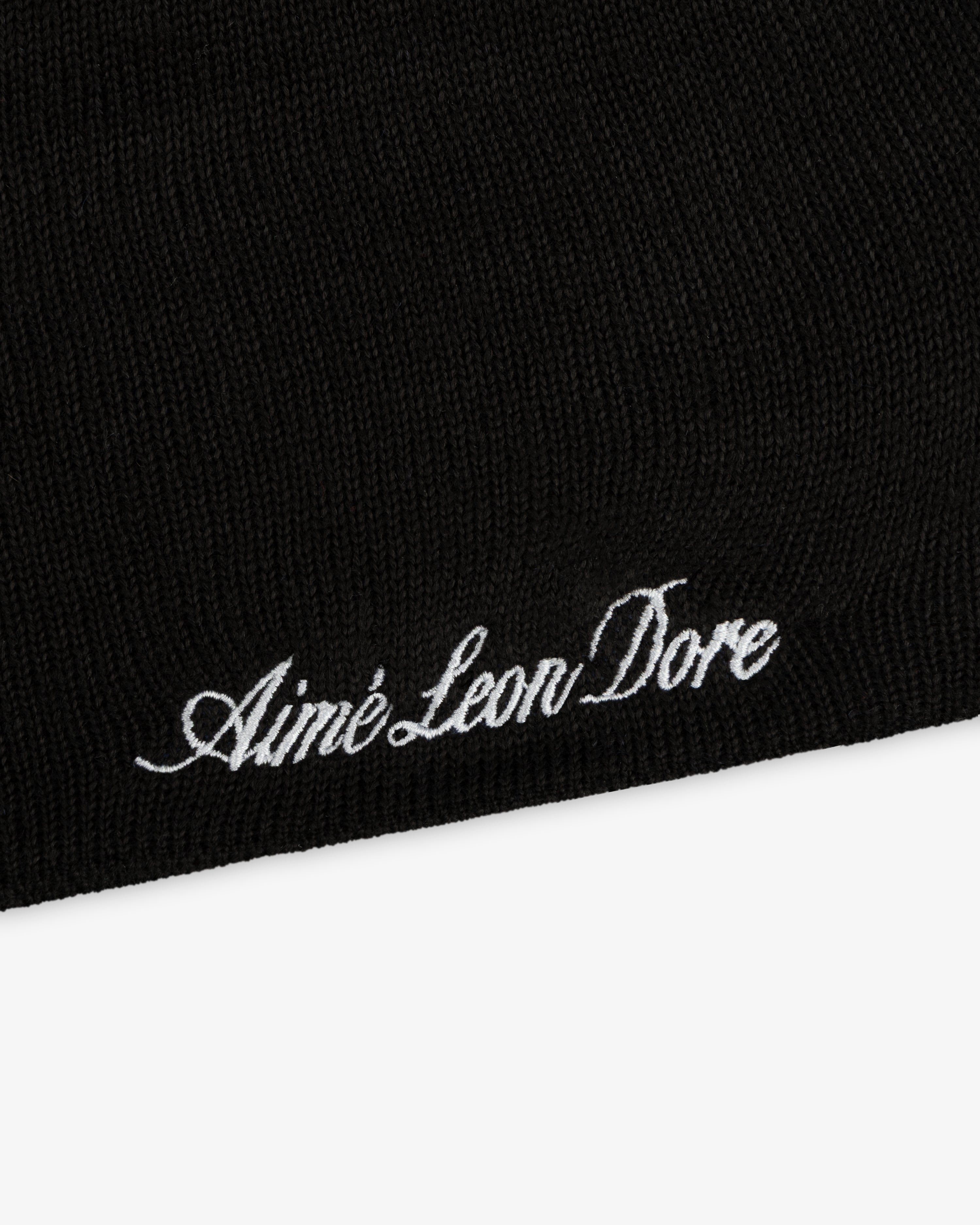 Black ALD / New Era Mets Beanie with white script embroidery reading Aimé Leon Dore.