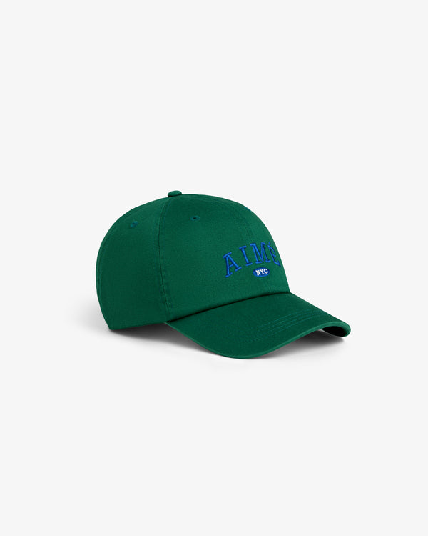 Aimé Souvenir Hat: green cap with blue “AIME NYC” embroidery, displayed on a plain white background.