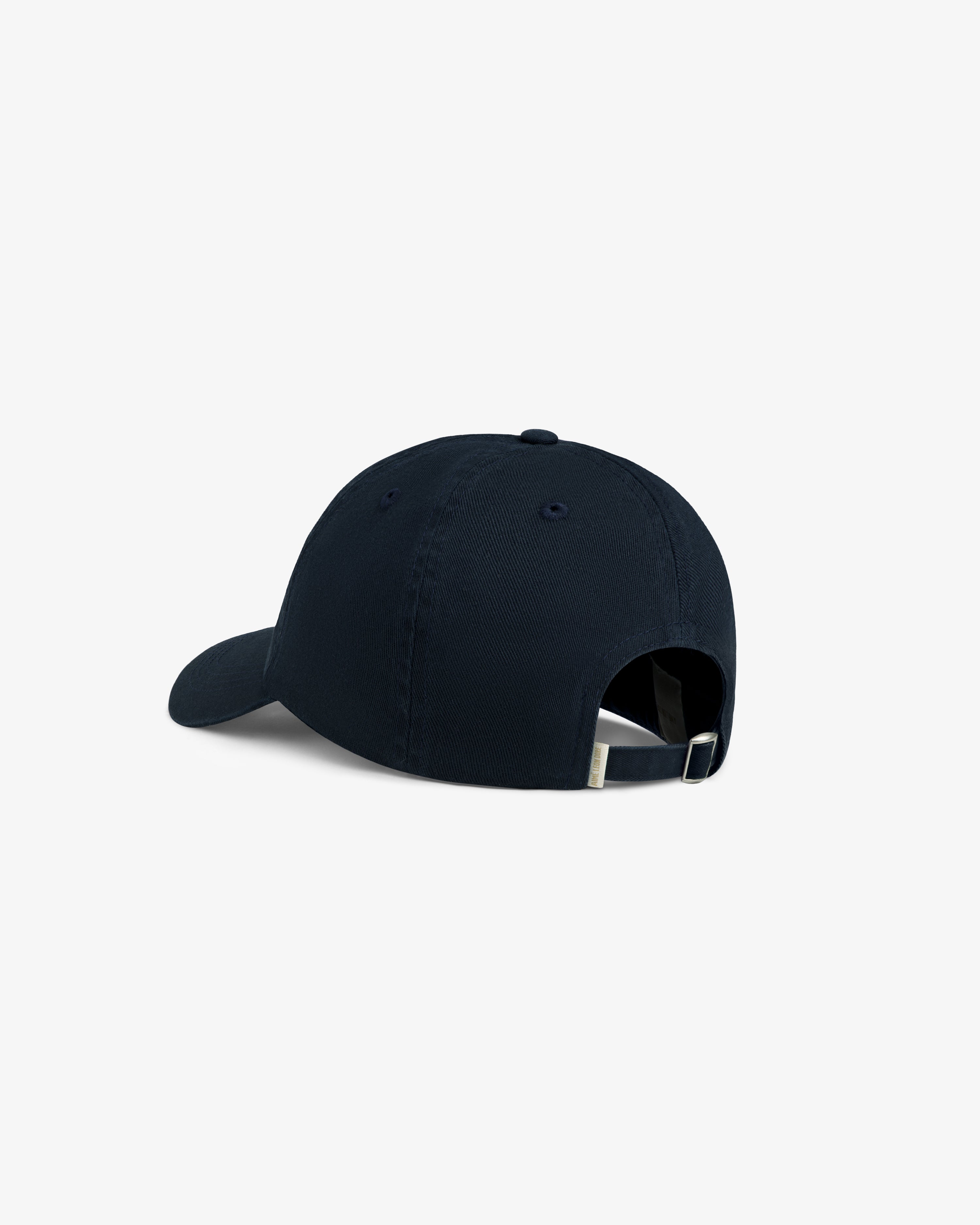 Aimé Souvenir Hat in black, shown from the back with an adjustable strap and metal buckle.