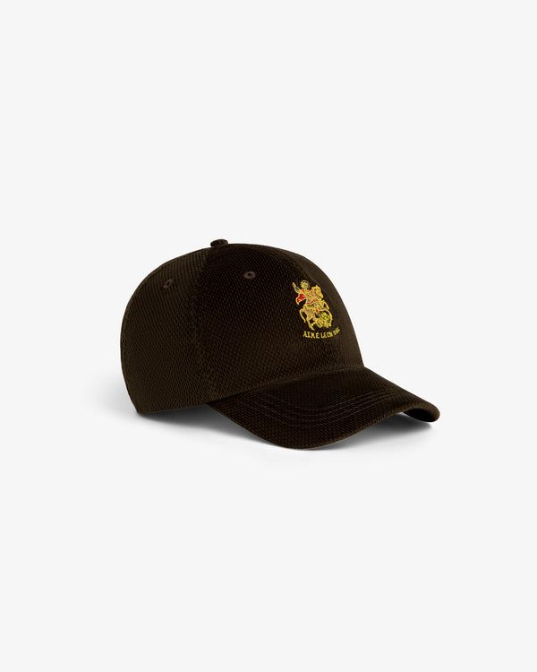 Saint George Corduroy Hat in dark brown with a small yellow and red crest logo embroidered on the front, angled left.