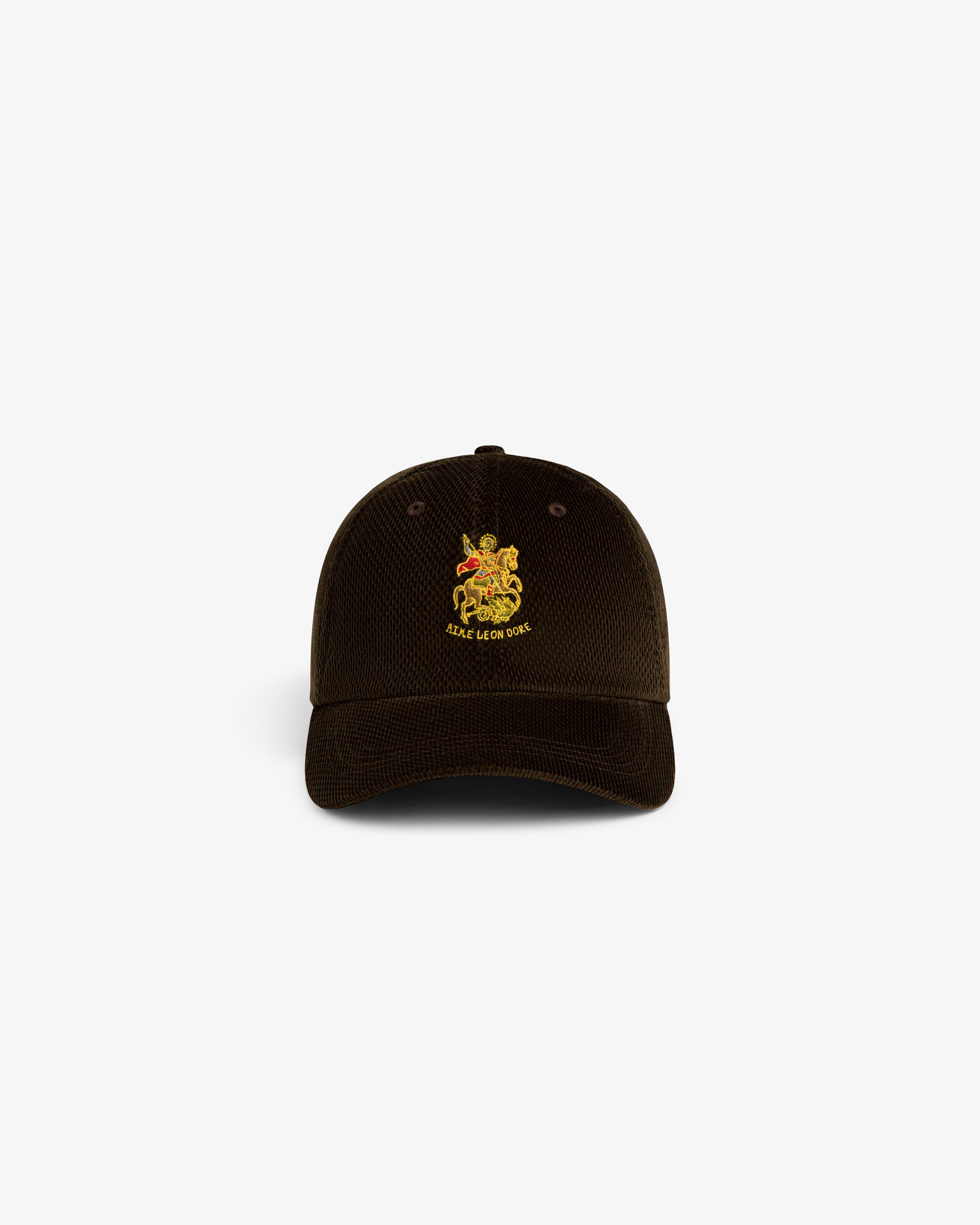 Brown corduroy Saint George Hat with yellow crest and SILAS & THE CAT text embroidered on the front.