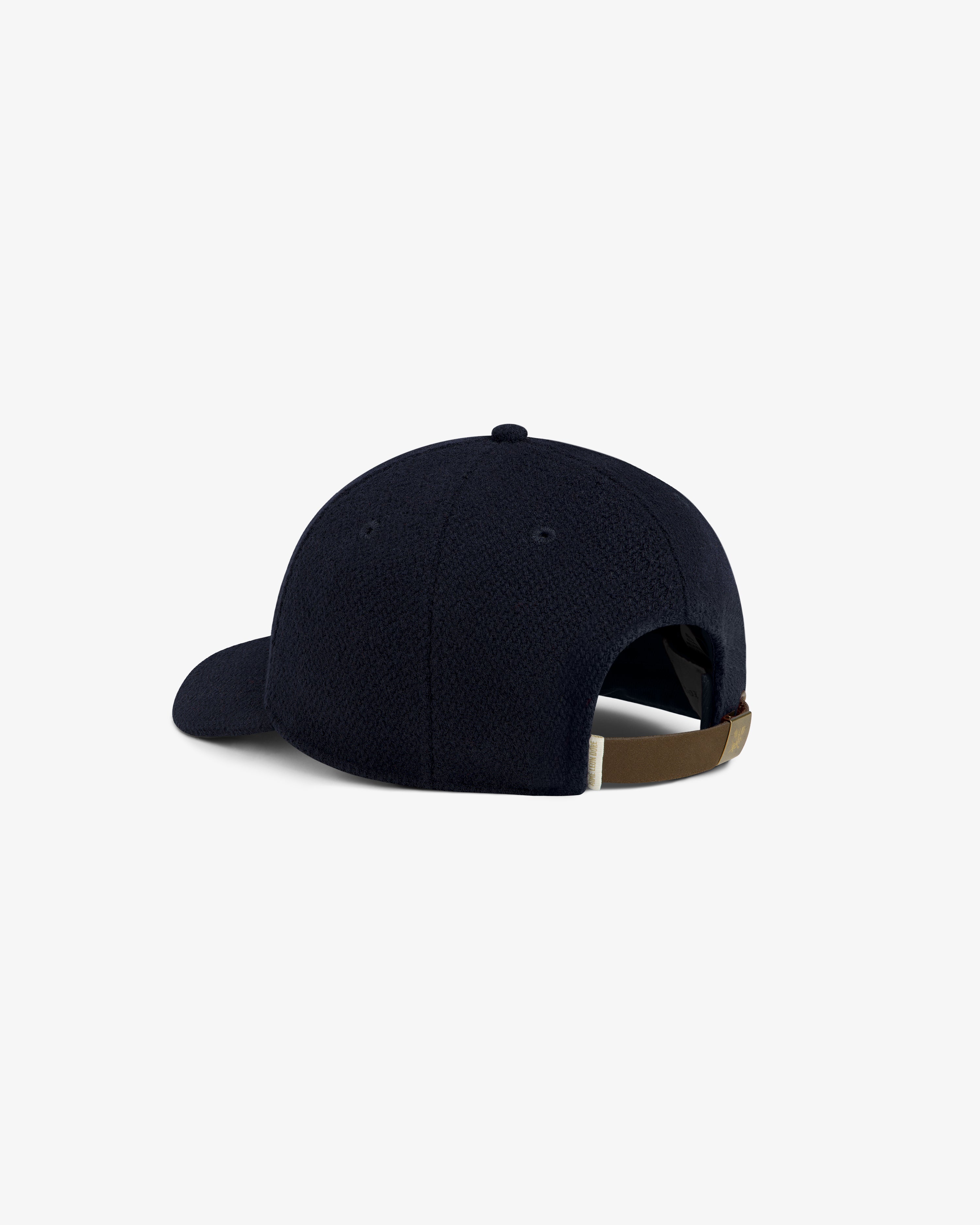 Rear view of a navy blue Wool Varsity Logo Hat with an adjustable brown strap.