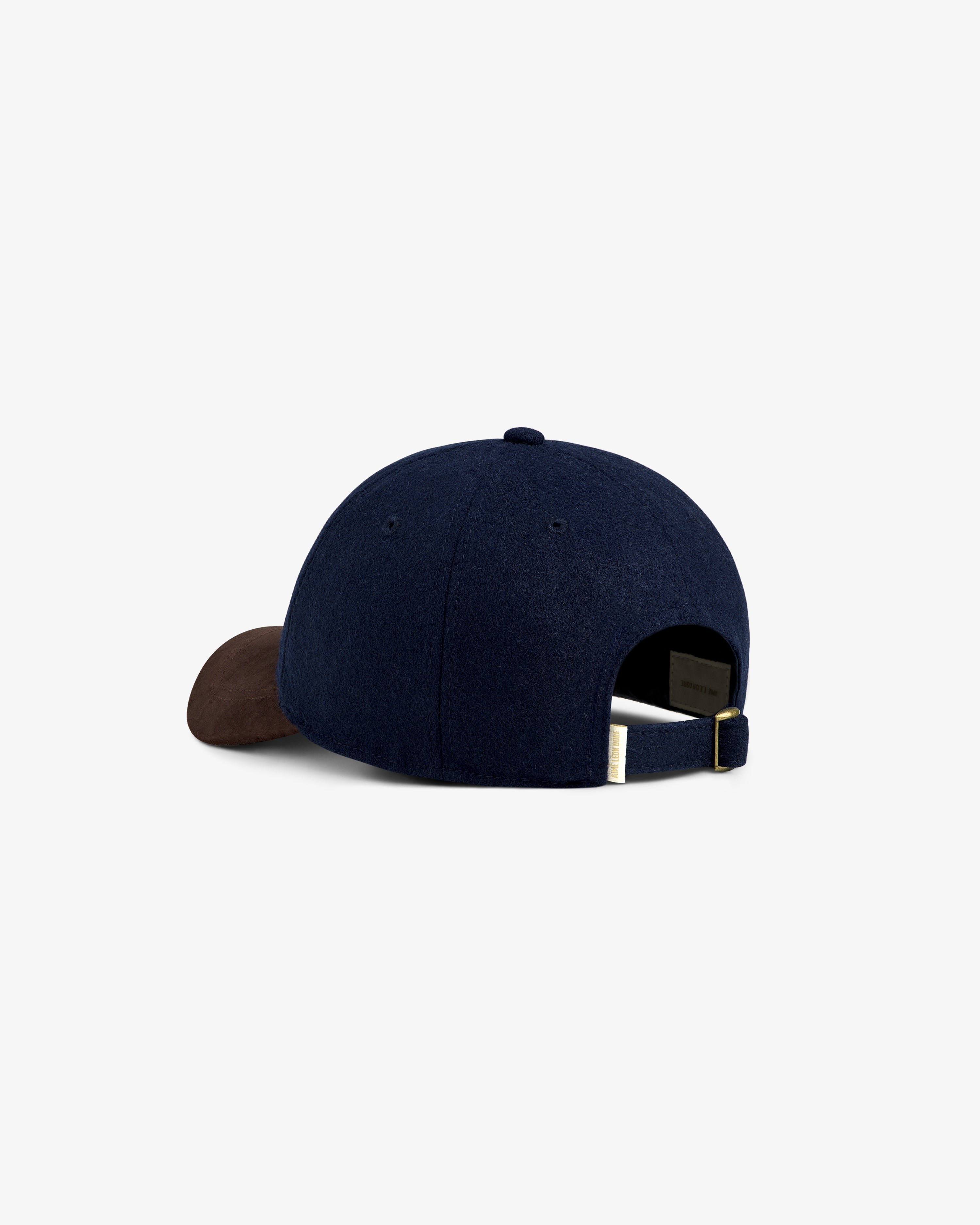 Triborough Chess Club Wool Hat in navy with a brown brim, rear view showing adjustable strap.