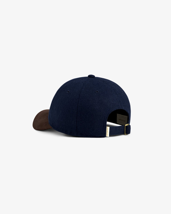 Triborough Chess Club Wool Hat in navy with a brown brim, rear view showing adjustable strap.