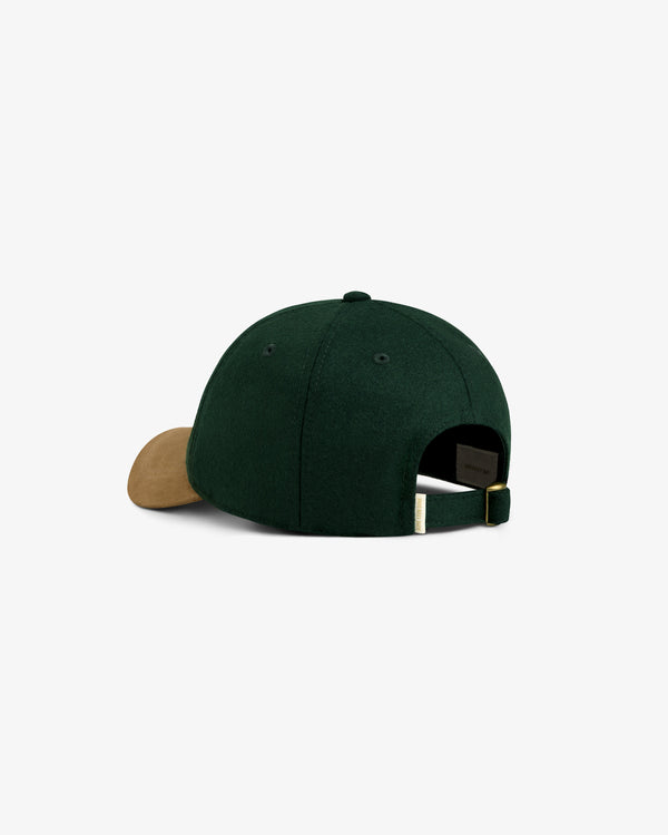 Triborough Chess Club Wool Hat in green with brown brim, shown from the back with adjustable strap and brass buckle.