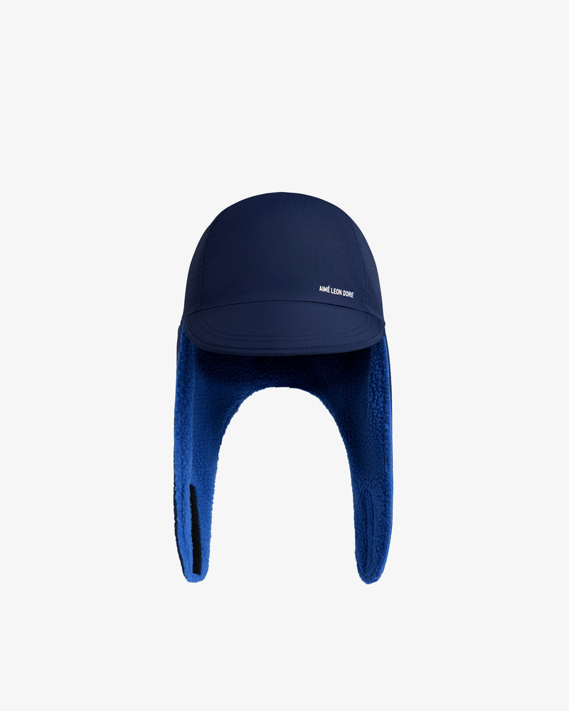 Navy blue Fleece Lined Earflap Hat with a fleece lining and brand text on the brim.