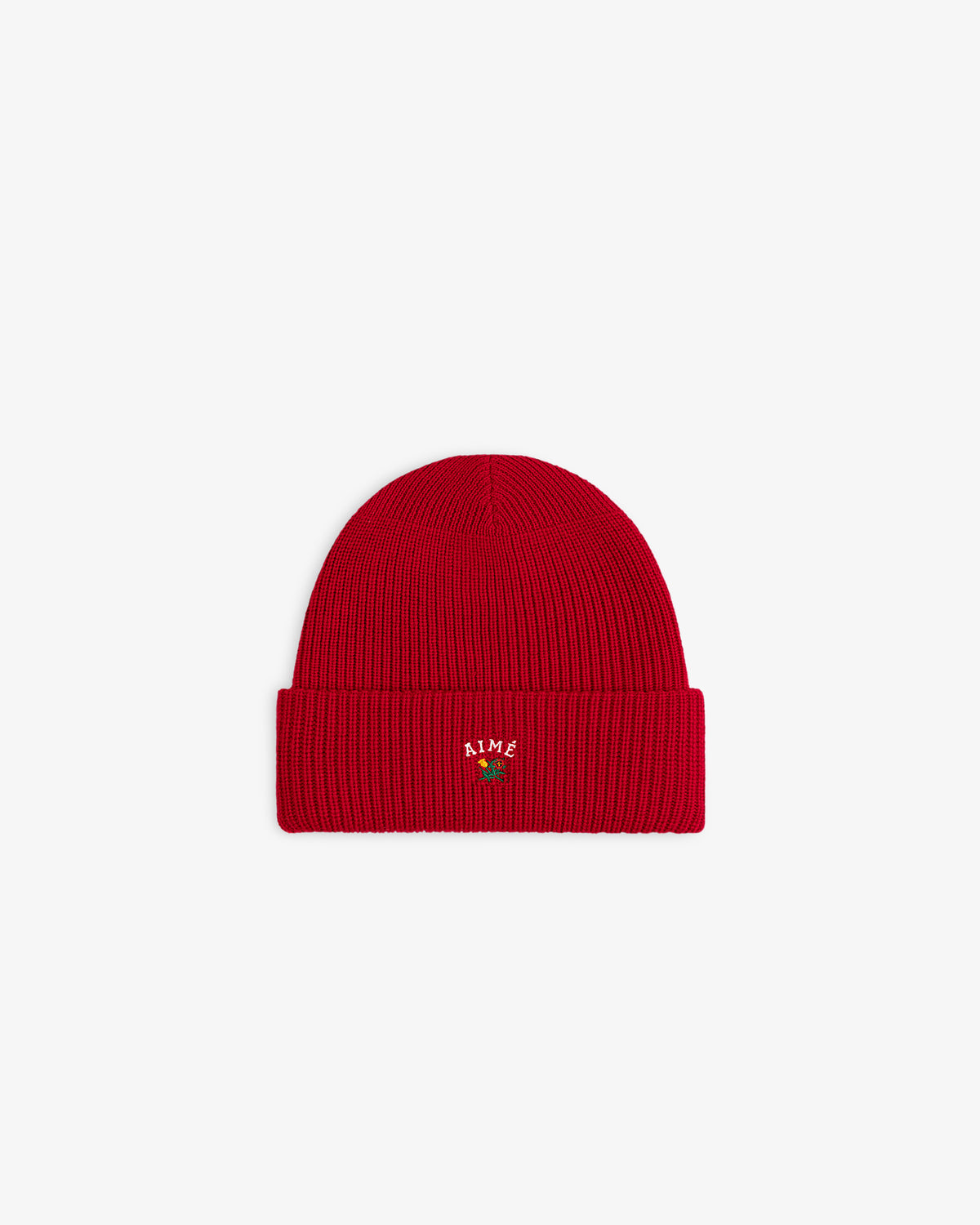 Crest Merino Wool Beanie in red with folded brim, embroidered text, and a rose at the front center.