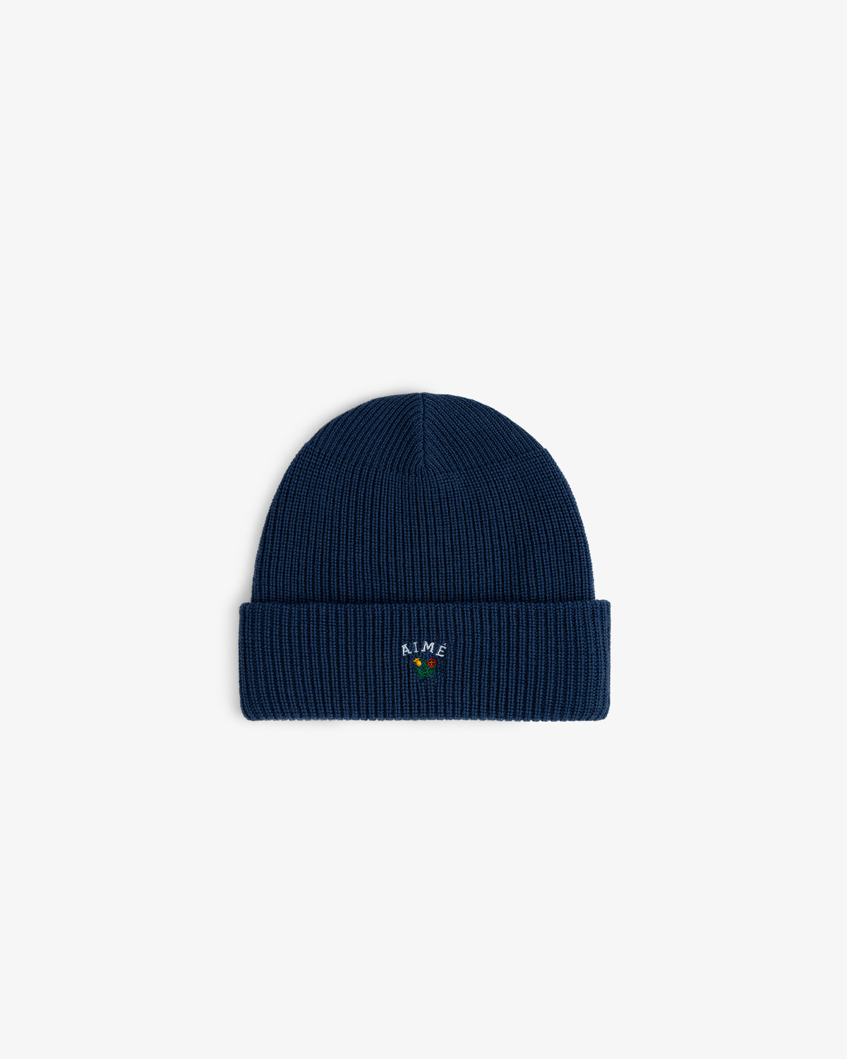 The Crest Merino Wool Beanie is navy, ribbed, with a cuff and vibrant embroidery on the front.
