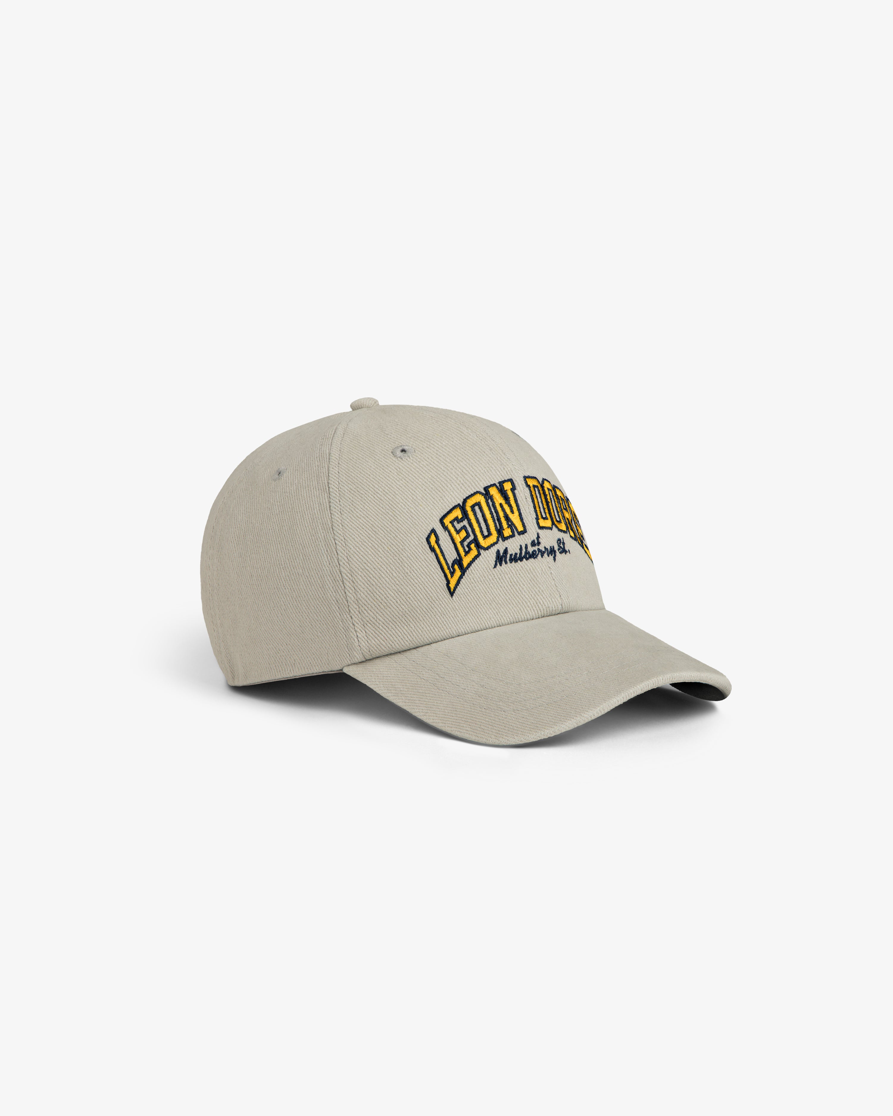 Mulberry Letterman Hat in beige with LEON DORE and Madeleine, NY embroidered in yellow and black on the front.