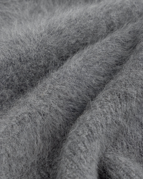 Close-up of a Fox Fur Hood, featuring soft, gray fuzzy material with folds and deep texture.