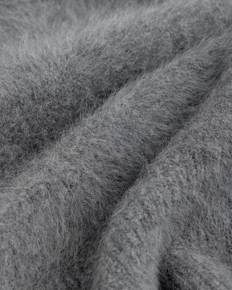 Close-up of a Fox Fur Hood, featuring soft, gray fuzzy material with folds and deep texture.