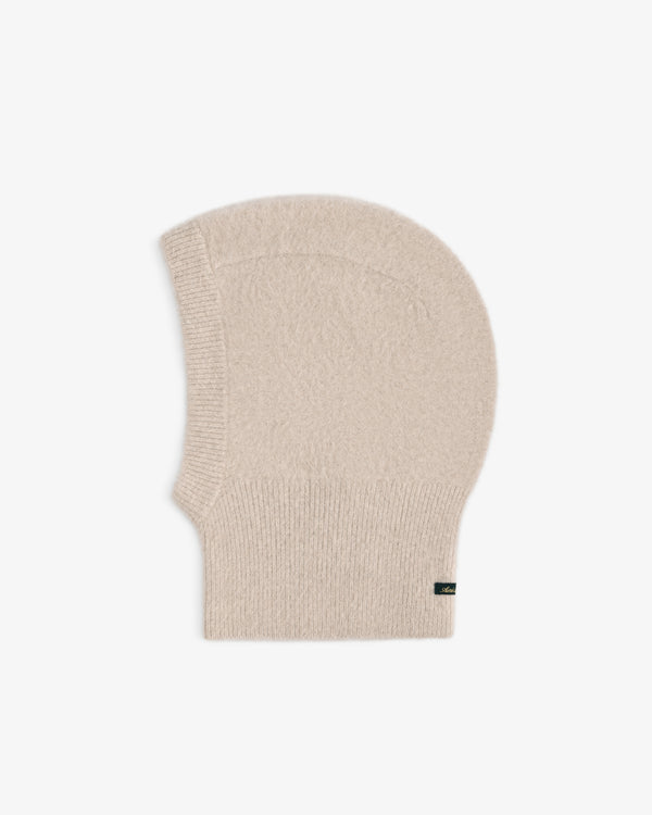 Beige knit Fox Fur Hood with a ribbed neck and a small side tag.