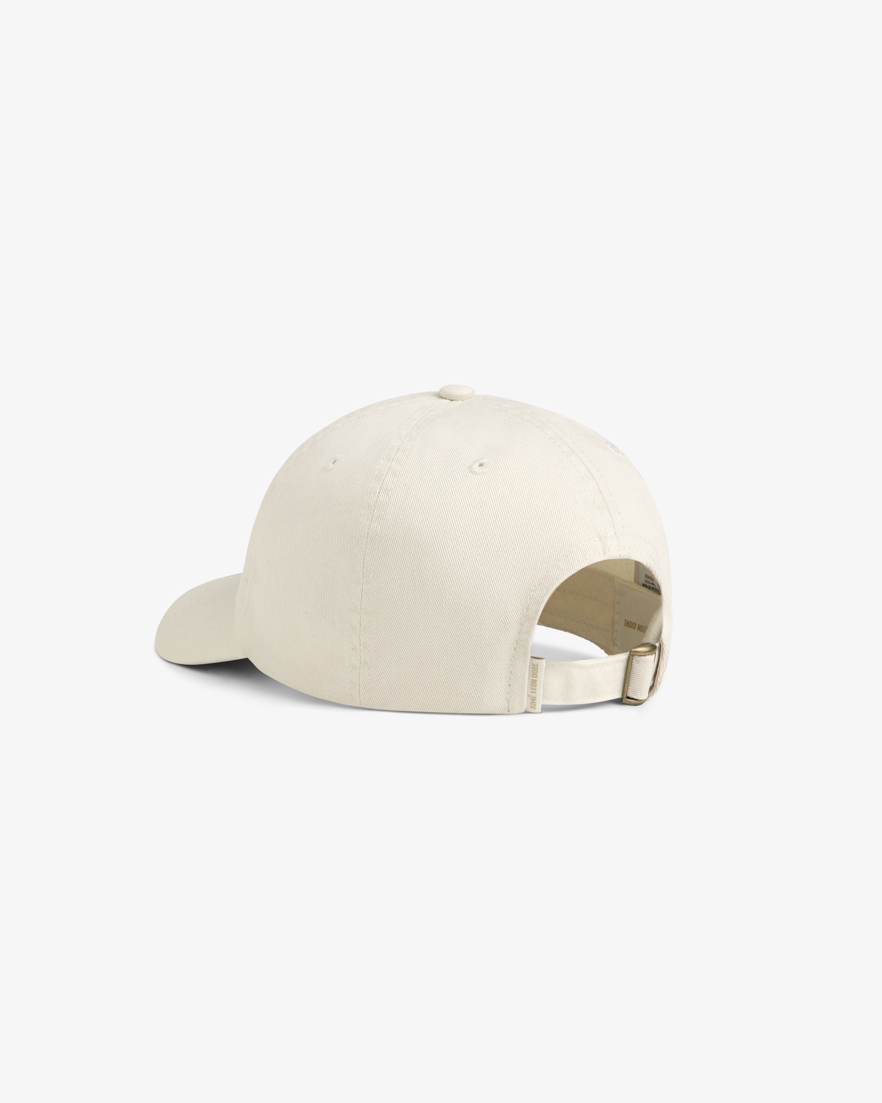 Stacked Logo Hat in beige, back view with adjustable strap and metal clasp shown on a white background.