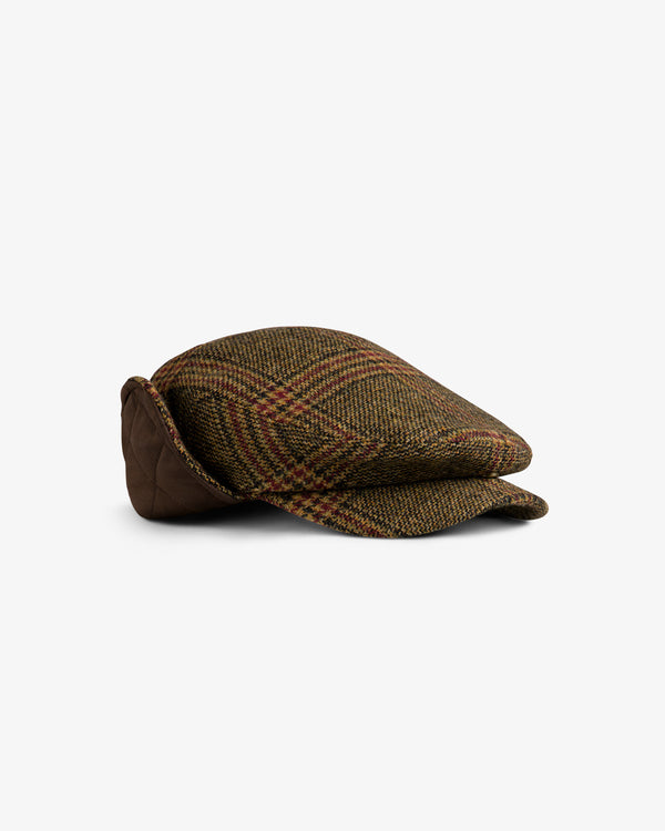 Plaid Tweed Driver’s Hat in brown and gold with a quilted ear flap folded down.