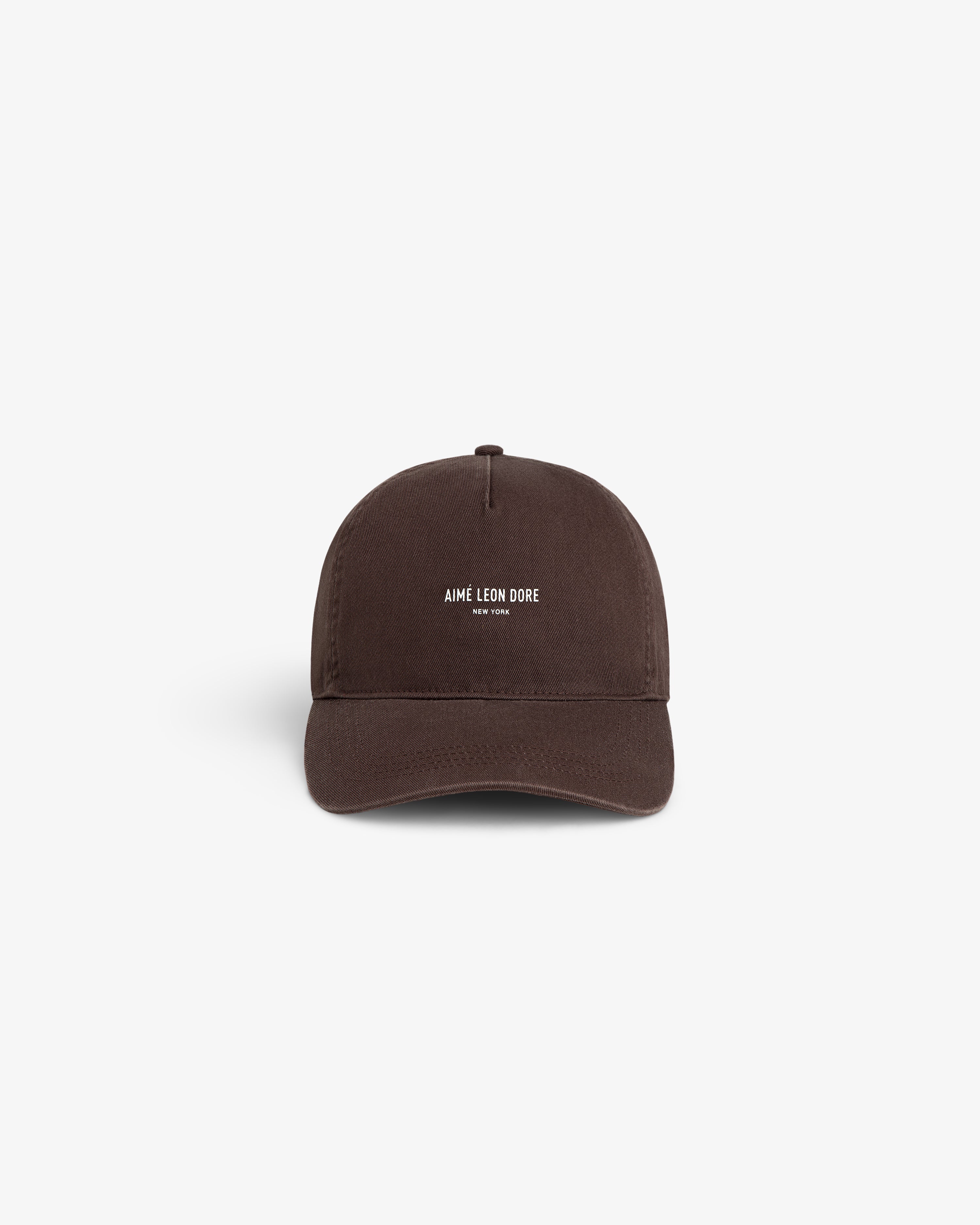 A brown Micro Logo Hat with white AIMÉ LEON DORE NEW YORK text on the front, shown on a white background.