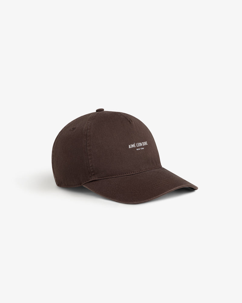 A brown Micro Logo Hat with white embroidered text on the front, shown against a plain white background.
