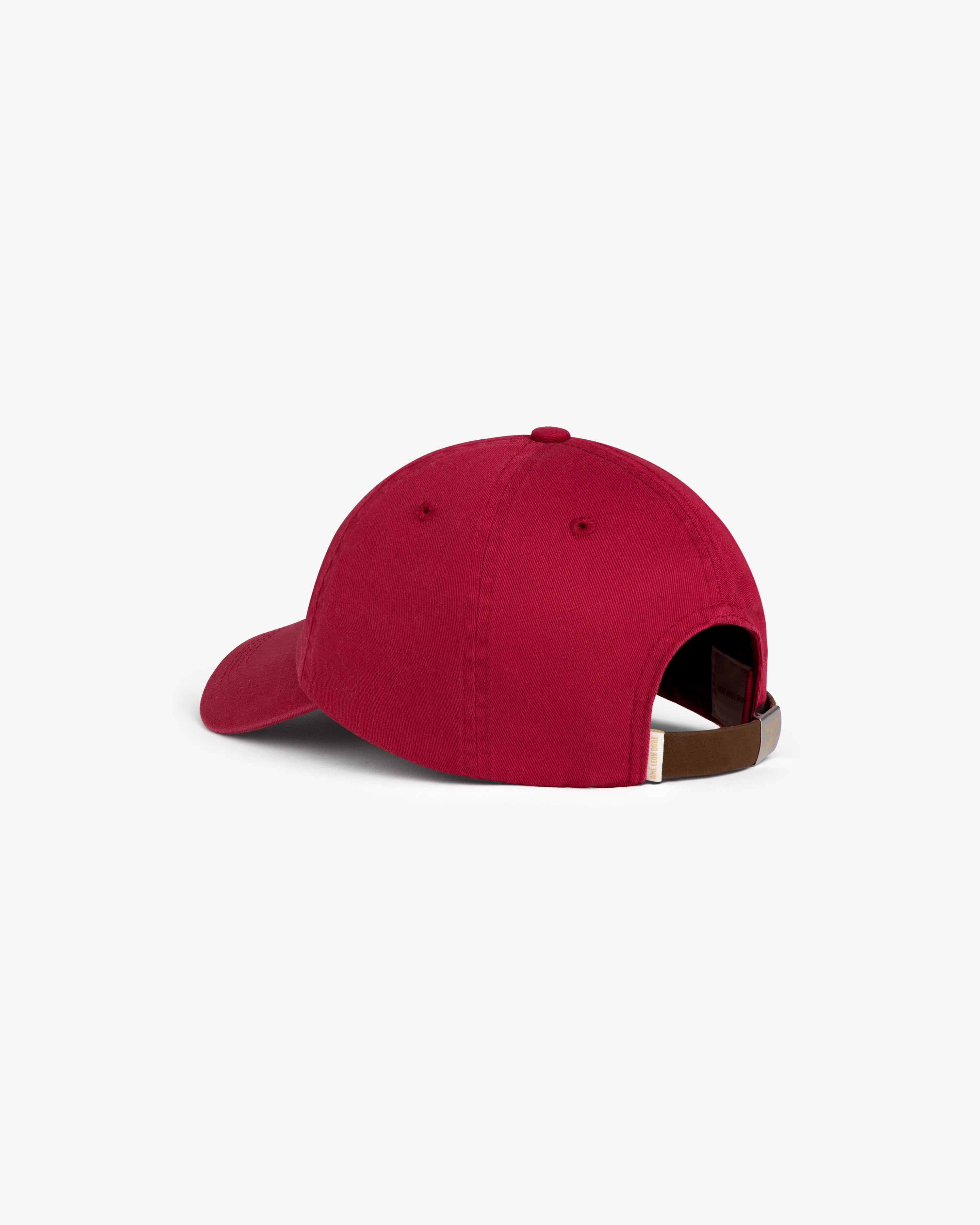 Crest Logo Hat in red, shown from the back with adjustable strap and metal buckle on white background.