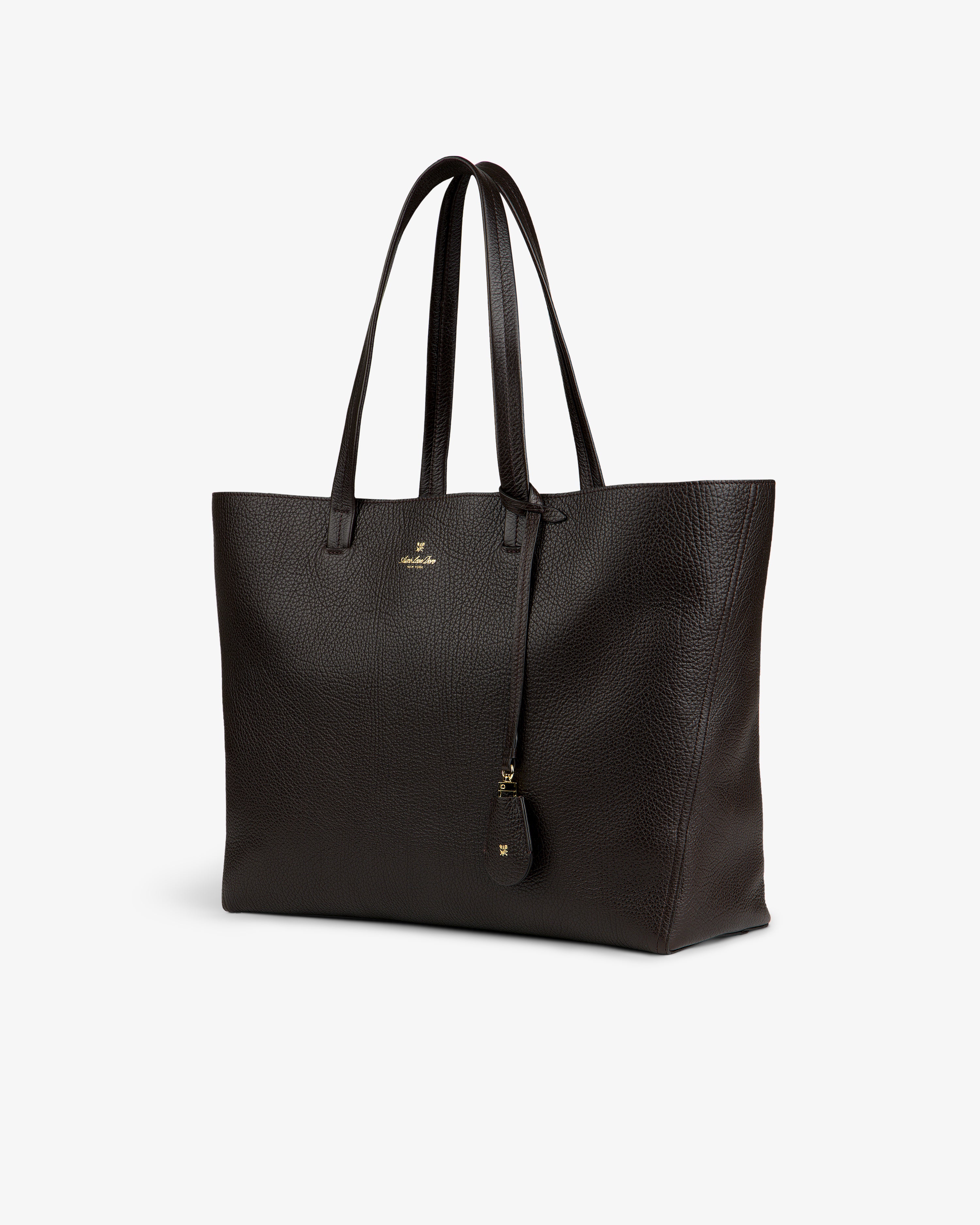 Tumbled Leather Tote Bag in dark brown with two handles and a hanging tag, shown on a plain white background.
