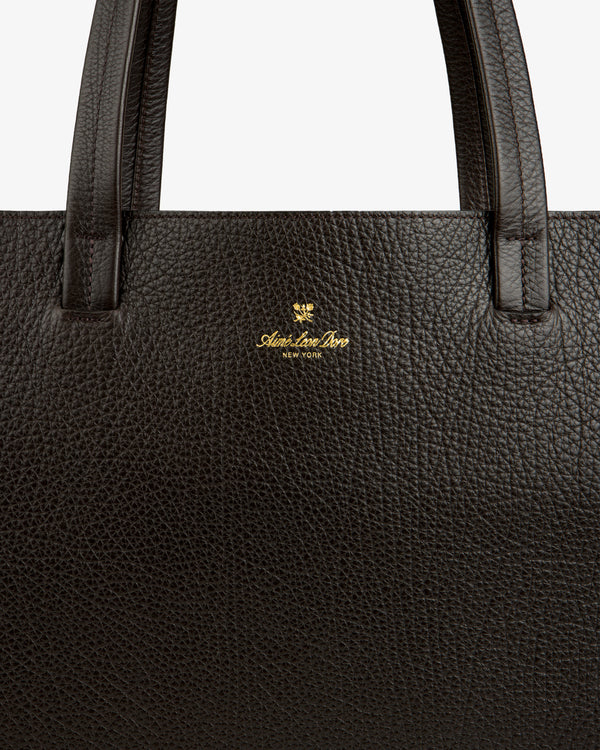 Close-up of a dark brown Tumbled Leather Tote Bag with gold Aspinal of London New York logo near the handle.