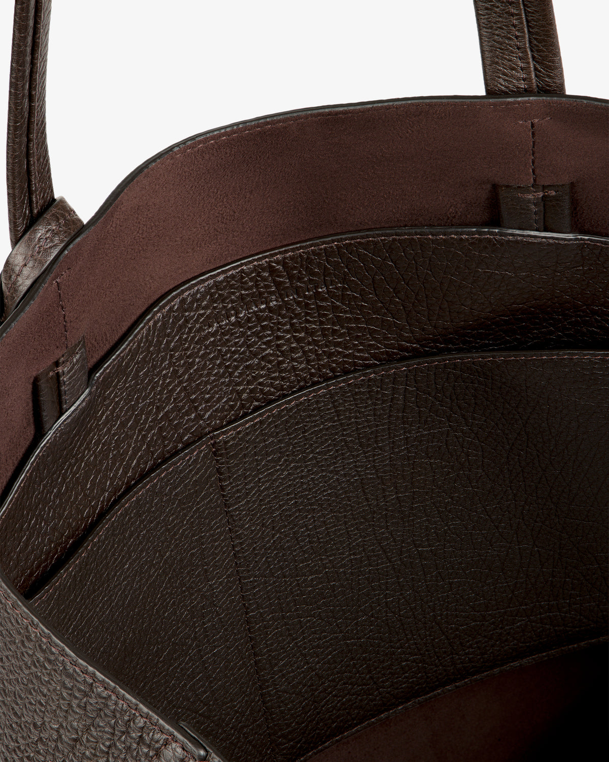 Close-up of Tumbled Leather Tote Bag’s brown textured interior with two compartments and smooth lining.