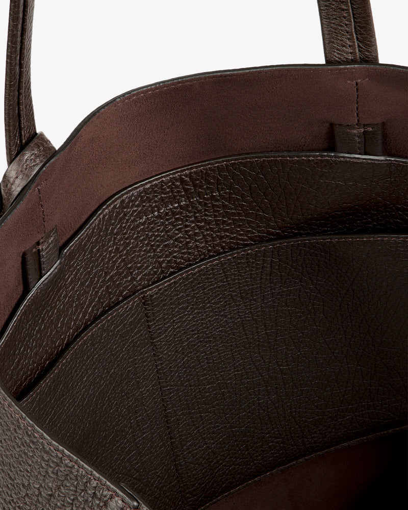 Close-up of Tumbled Leather Tote Bag’s brown textured interior with two compartments and smooth lining.