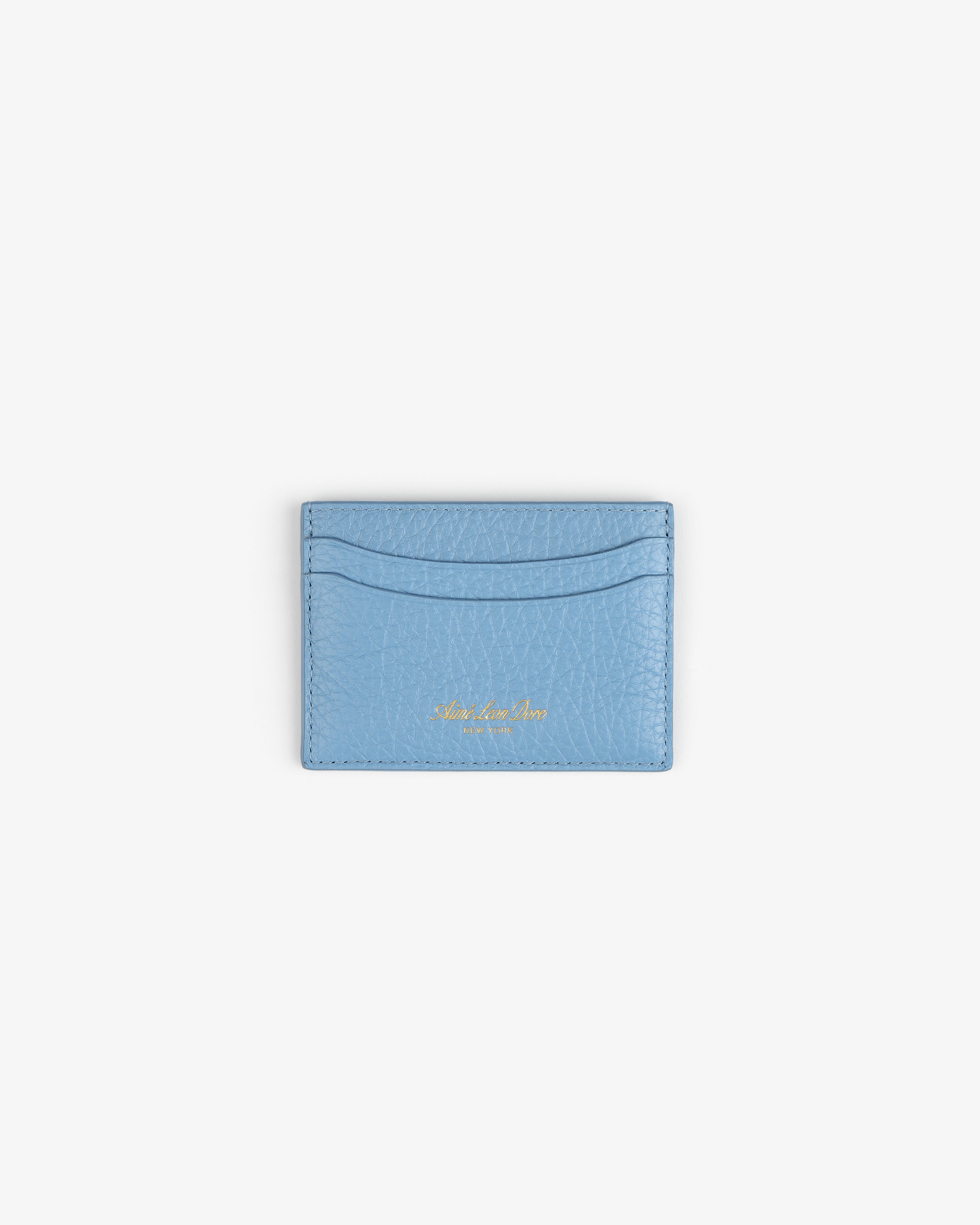 Tumbled Leather Card Holder in light blue with gold embossing, displayed on a plain white background.