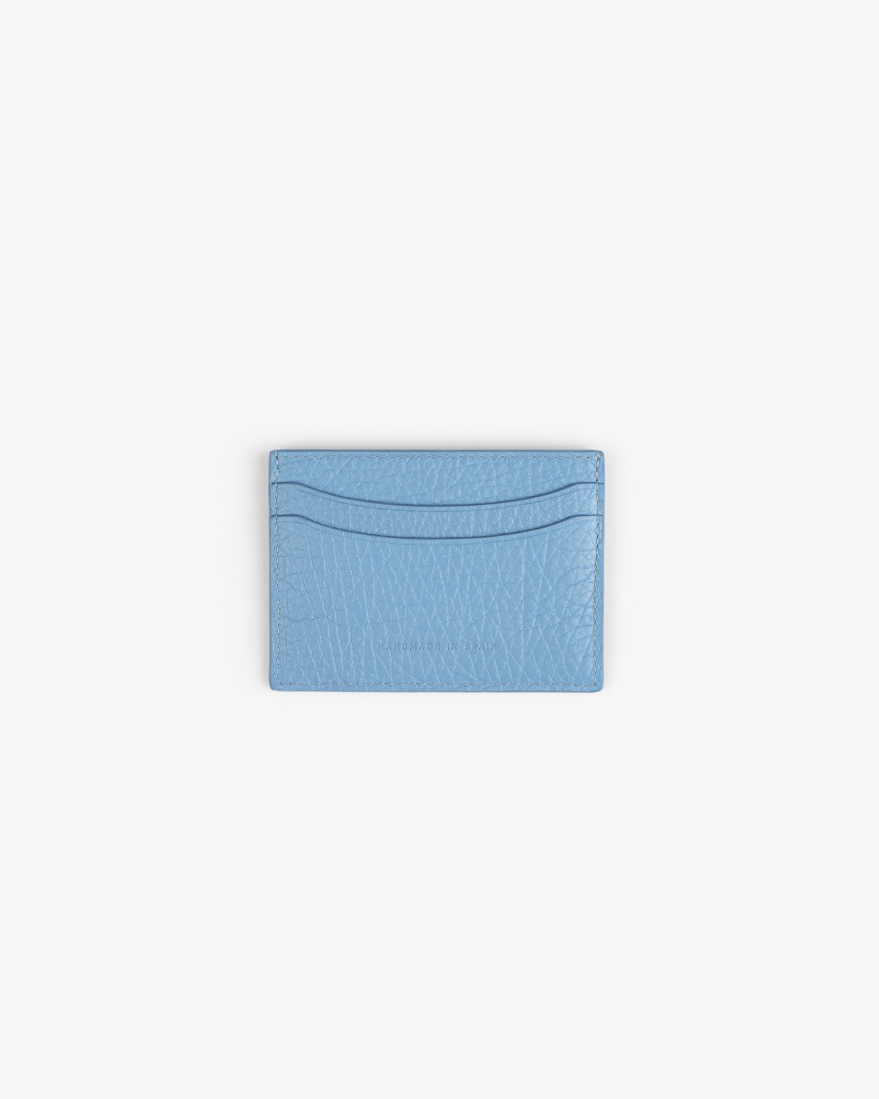 Tumbled Leather Card Holder in light blue with two slots, shown on a plain white background.