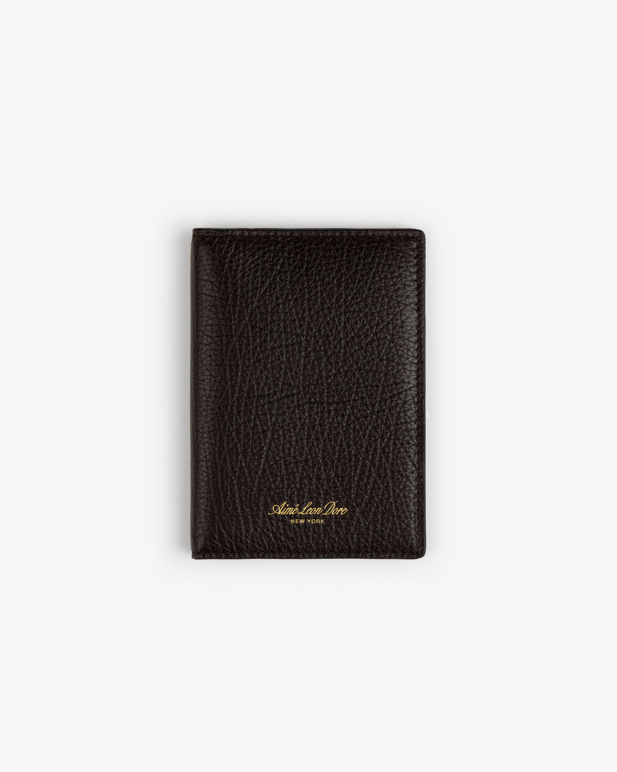 A closed Tumbled Leather Passport Holder in textured dark brown leather with gold text, on a white background.