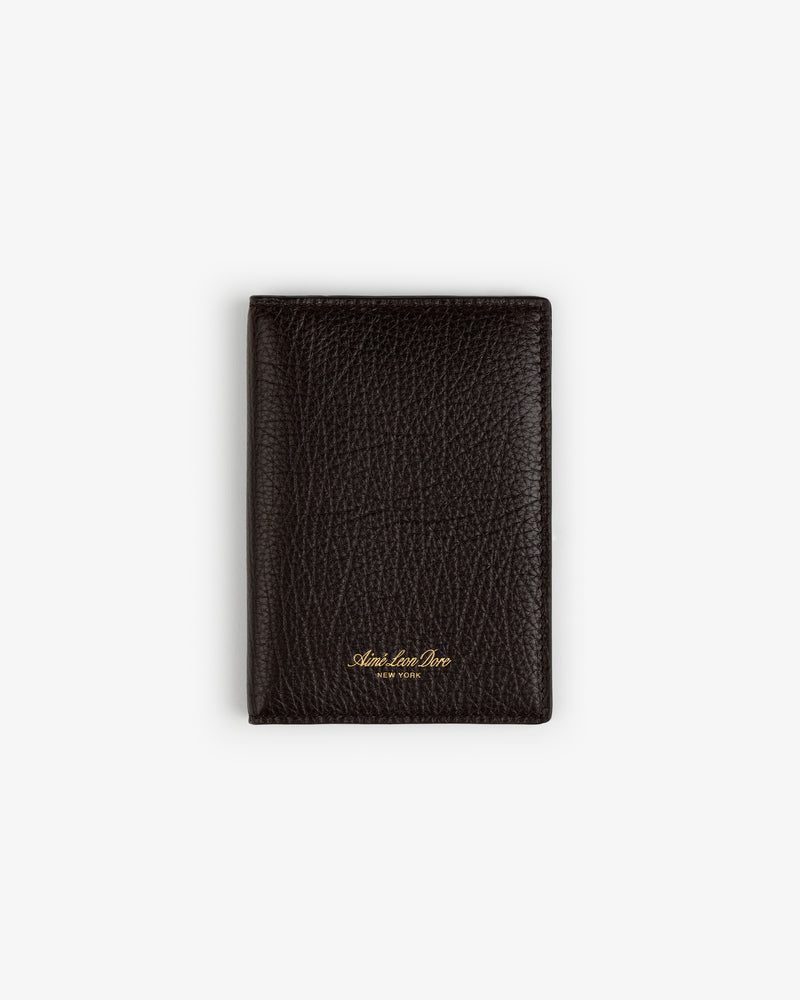 A closed Tumbled Leather Passport Holder in textured dark brown leather with gold text, on a white background.