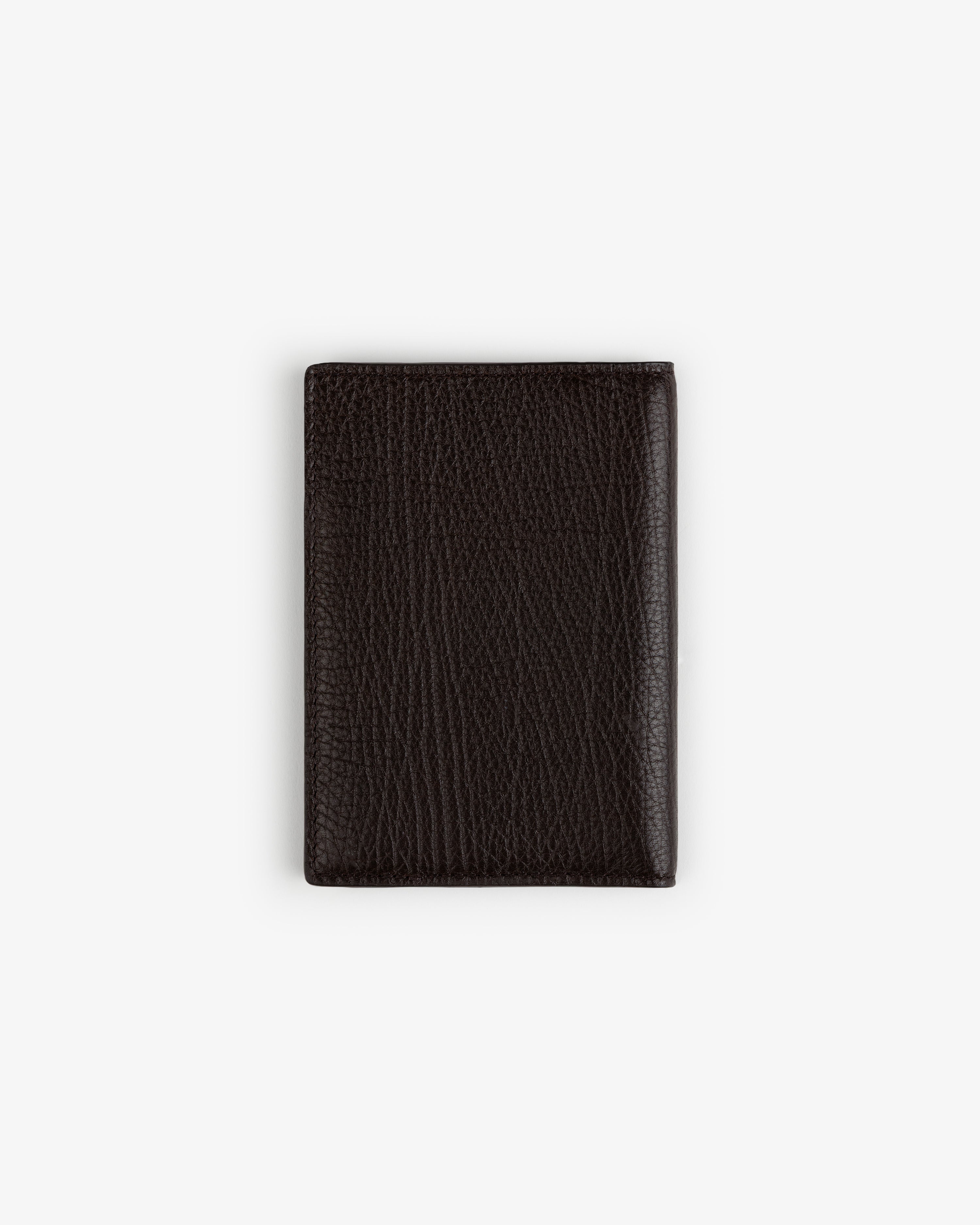 Tumbled Leather Passport Holder in dark brown, closed and upright on a plain white background.