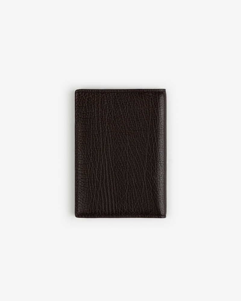 Tumbled Leather Passport Holder in dark brown, closed and upright on a plain white background.