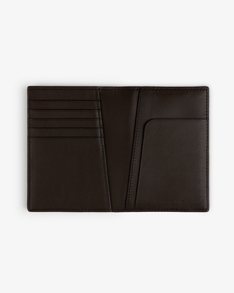 The Tumbled Leather Passport Holder in dark brown, with card slots and pocket, displayed on a white background.