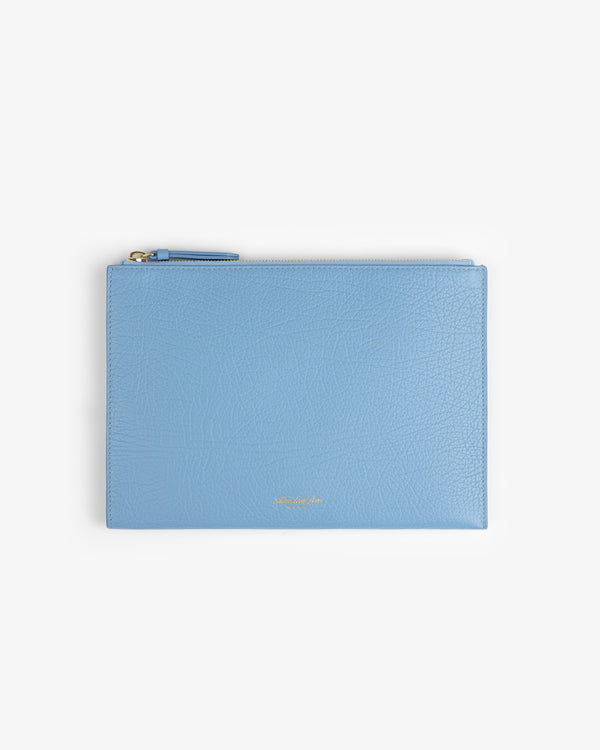Small Tumbled Leather Pouch: flat, light blue leather, gold text at bottom center, and a zipper closure.