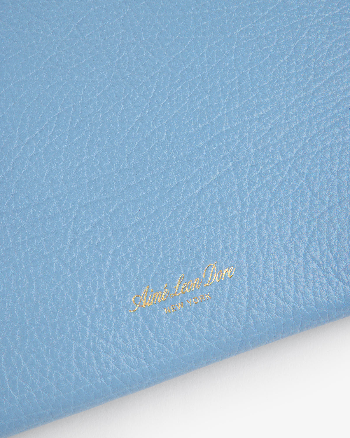 Light blue Small Tumbled Leather Pouch with gold embossed Aimé Leon Dore NEW YORK text in the lower quadrant.