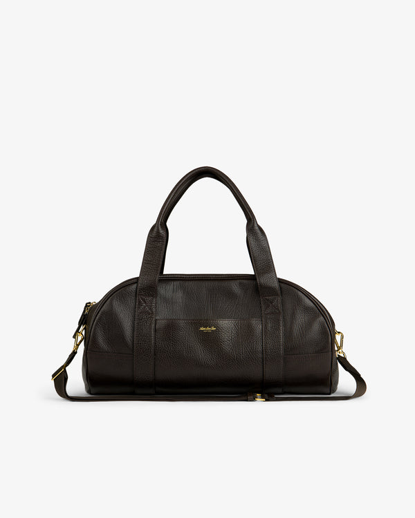 Tumbled Leather Duffle in dark brown with gold hardware, dual handles, and detachable strap on a white background.