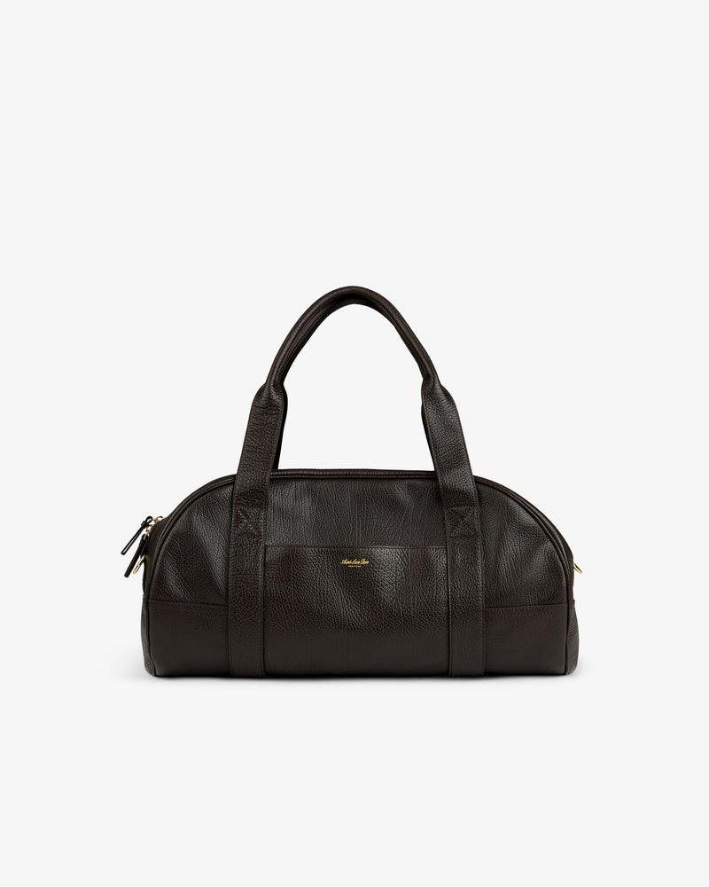 Tumbled Leather Duffle in dark brown with dual handles, gold zippers, and a small gold front logo.