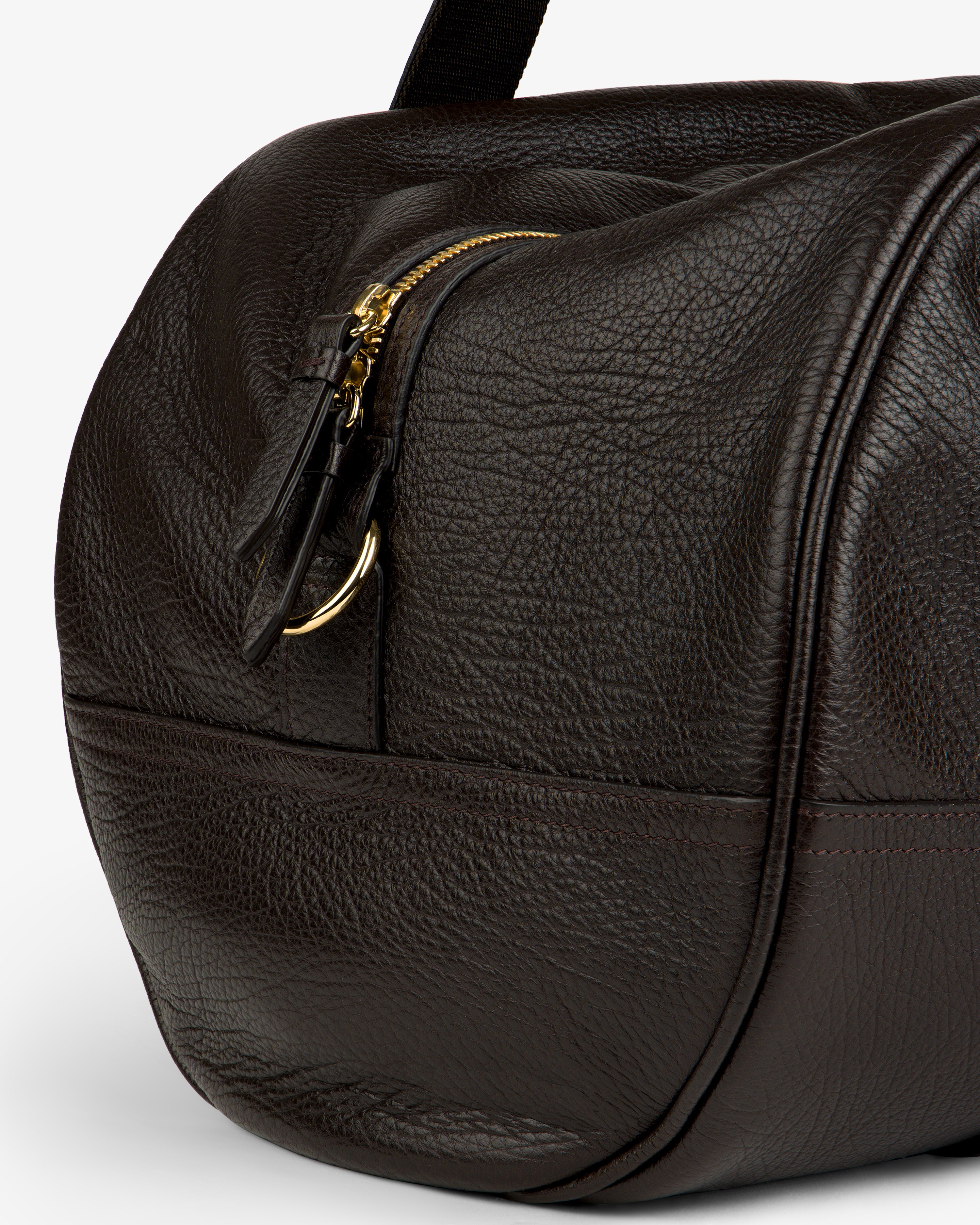 Close-up of the Tumbled Leather Duffle in dark brown with textured leather, gold zipper, and visible stitching.
