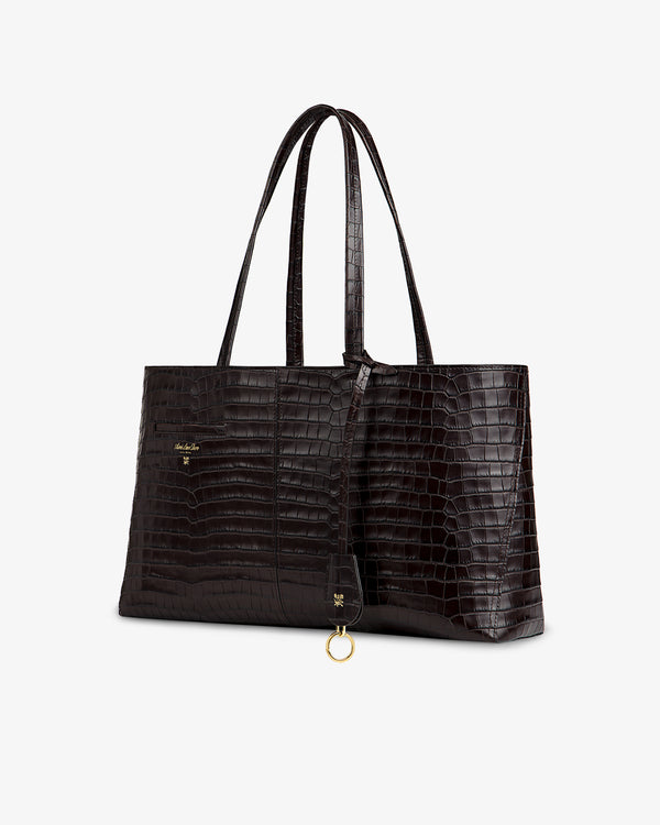 Croc-Embossed Leather Shoulder Bag in dark brown with thin straps and a gold circular charm.