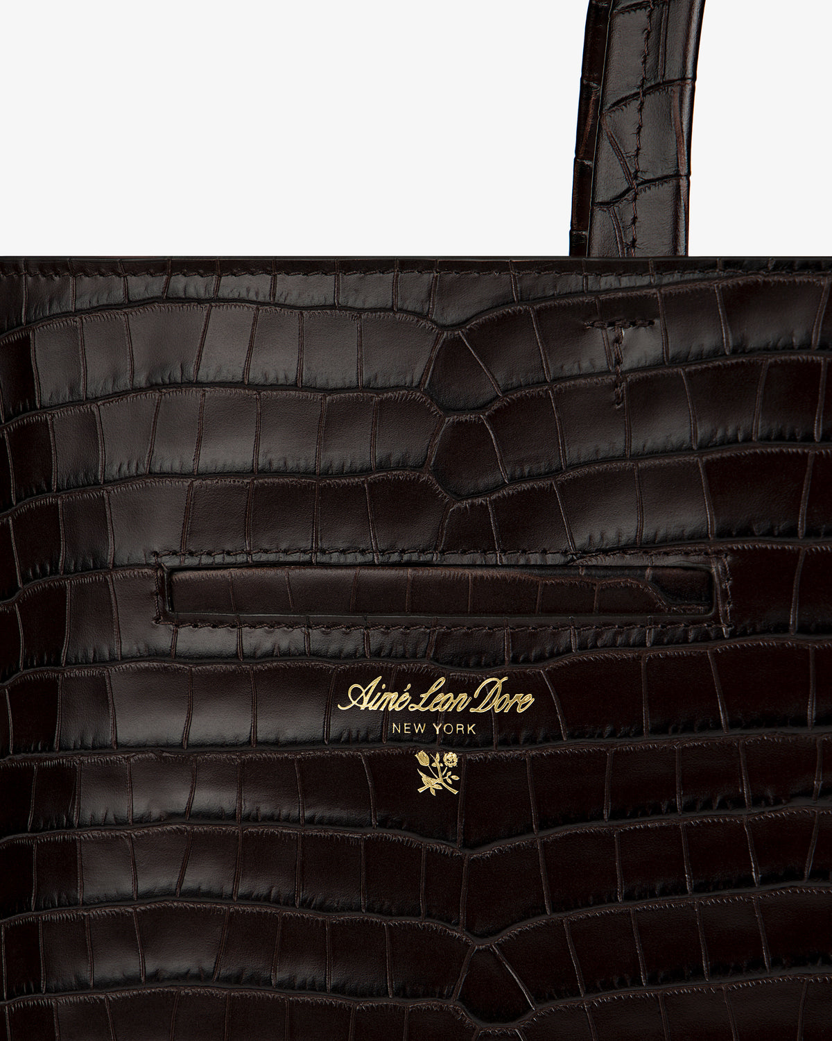 Dark brown croc-embossed leather shoulder bag with a gold-tone brand logo and floral emblem.
