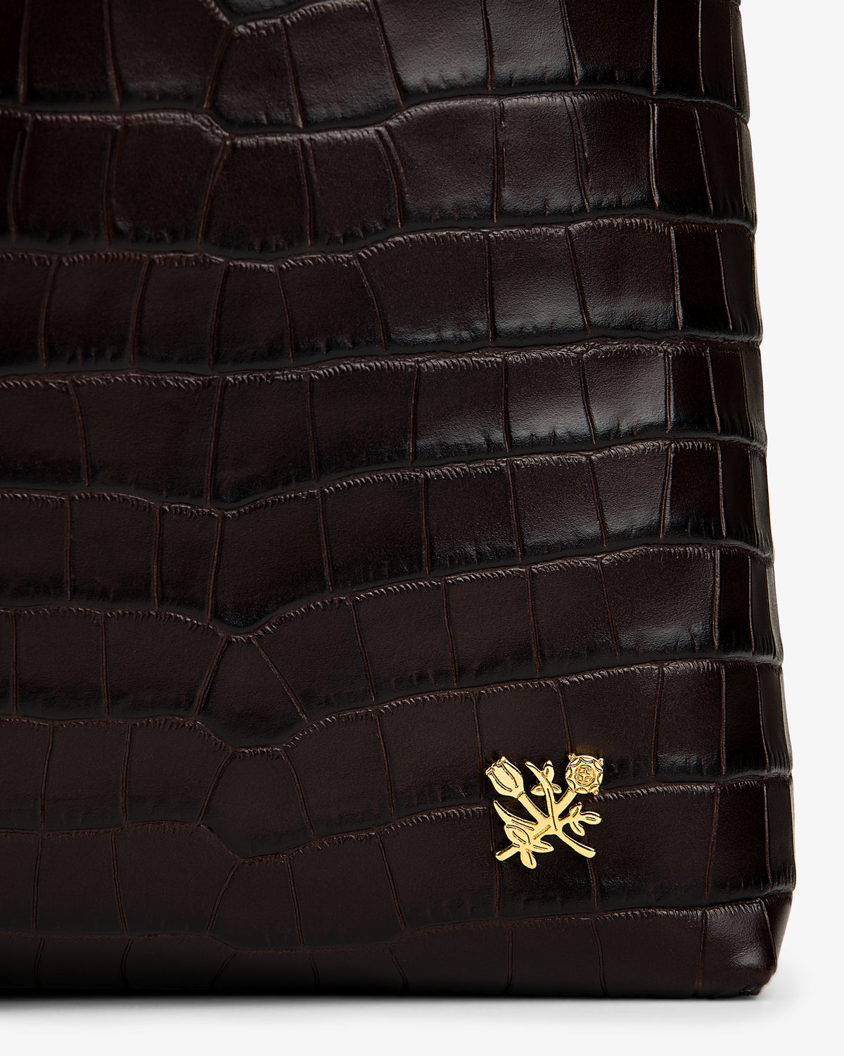 Dark brown croc-embossed leather Croc-Embossed Leather Shoulder Bag with a gold flower emblem.