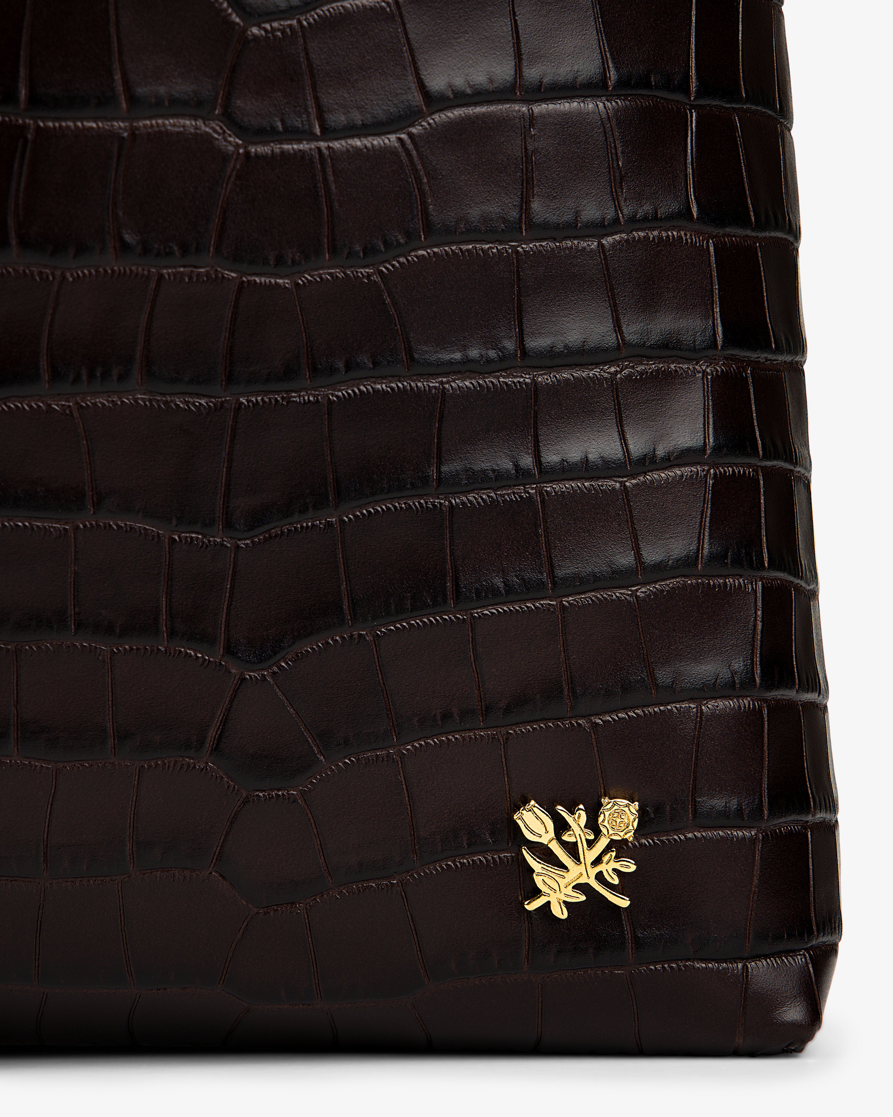 Dark brown croc-embossed leather Croc-Embossed Leather Shoulder Bag with a gold flower emblem.
