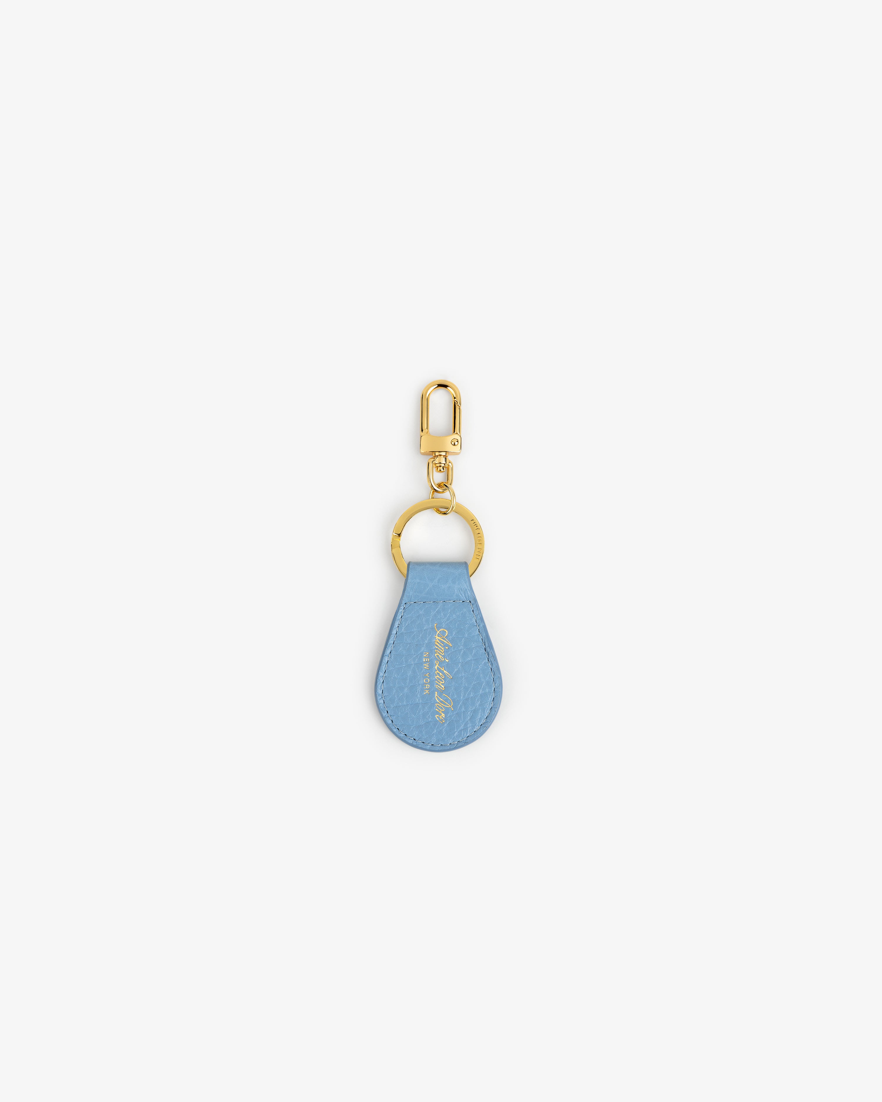 Tumbled Leather Key Fob with a light blue teardrop tag and gold keyring on a white background.