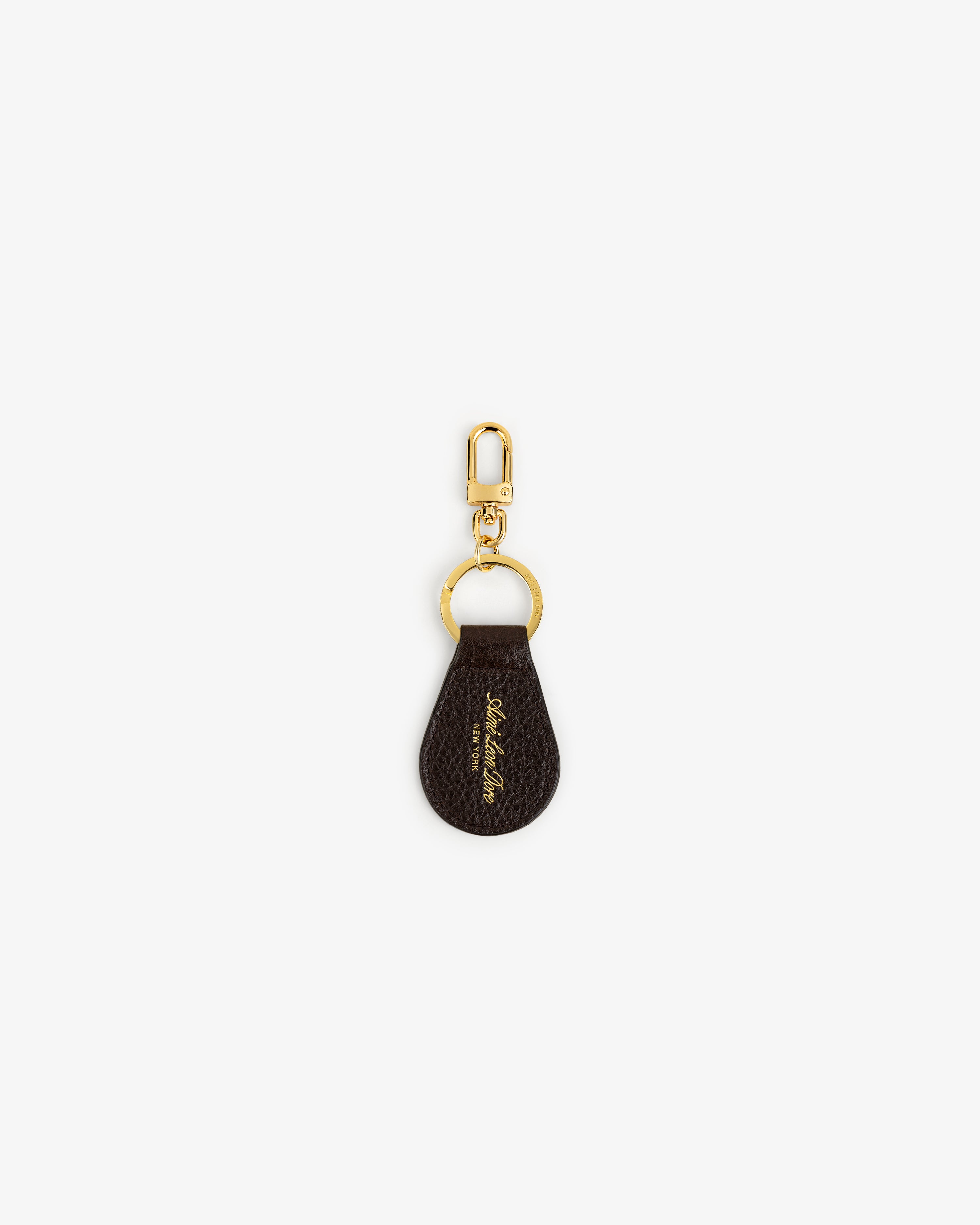 Tumbled Leather Key Fob in brown with gold hardware and cursive text, shown on a white background.