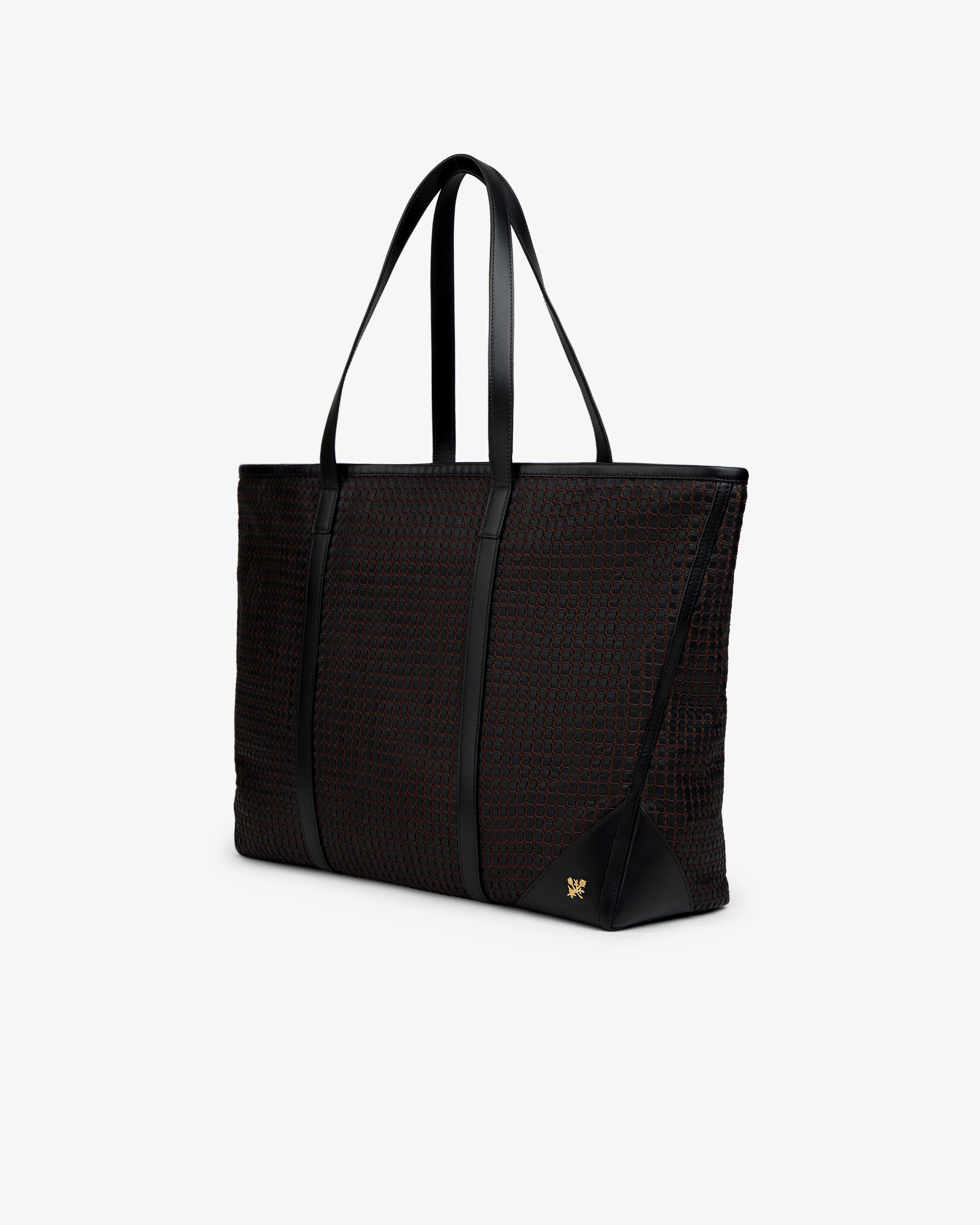Black woven leather tote bag with two shoulder straps and a gold logo emblem.