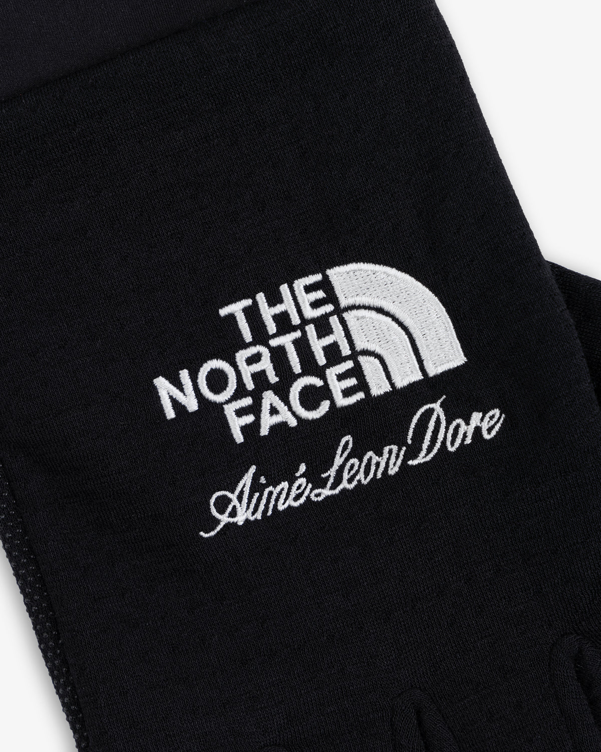 ALD / The North Face DOTKNIT™ Liner Gloves in black with white embroidered logos.