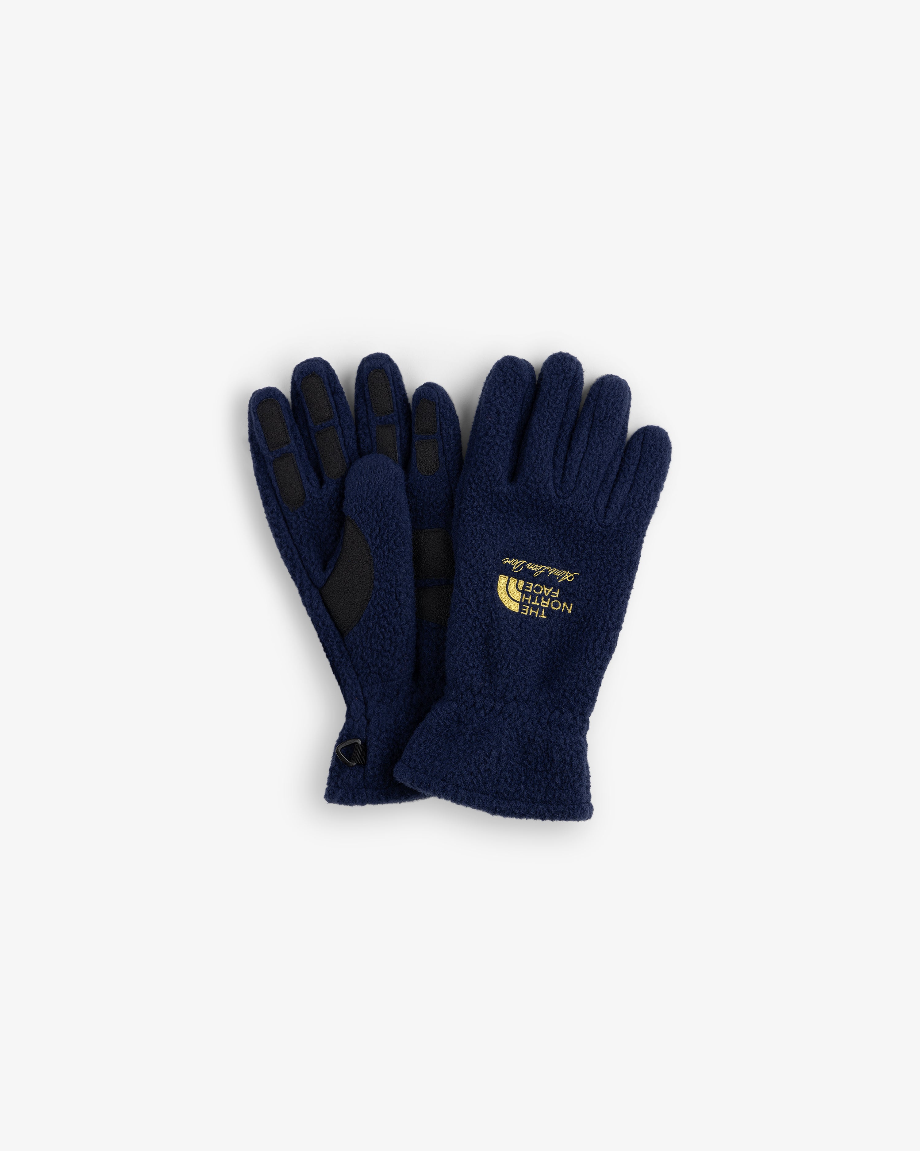 ALD / The North Face navy fleece gloves with black grips and yellow logo on the back of one glove.